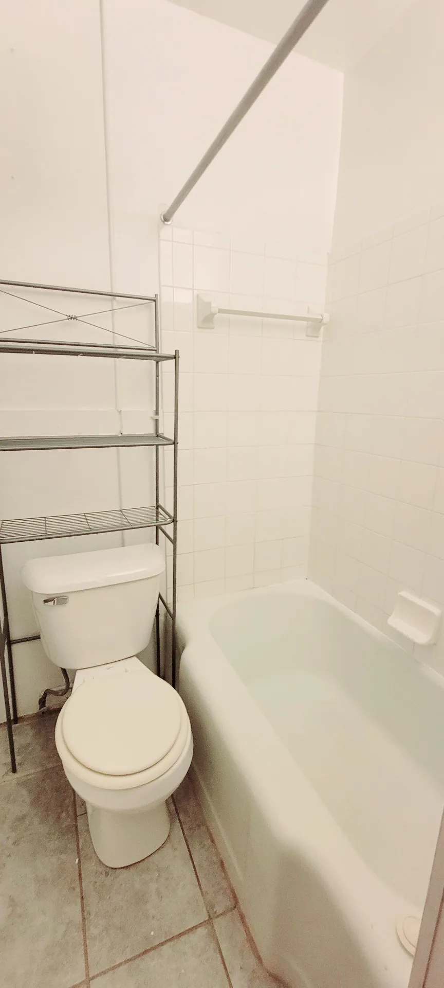 2054 Iuka Ave. C full bathroom with tub, toilet, and tile floor