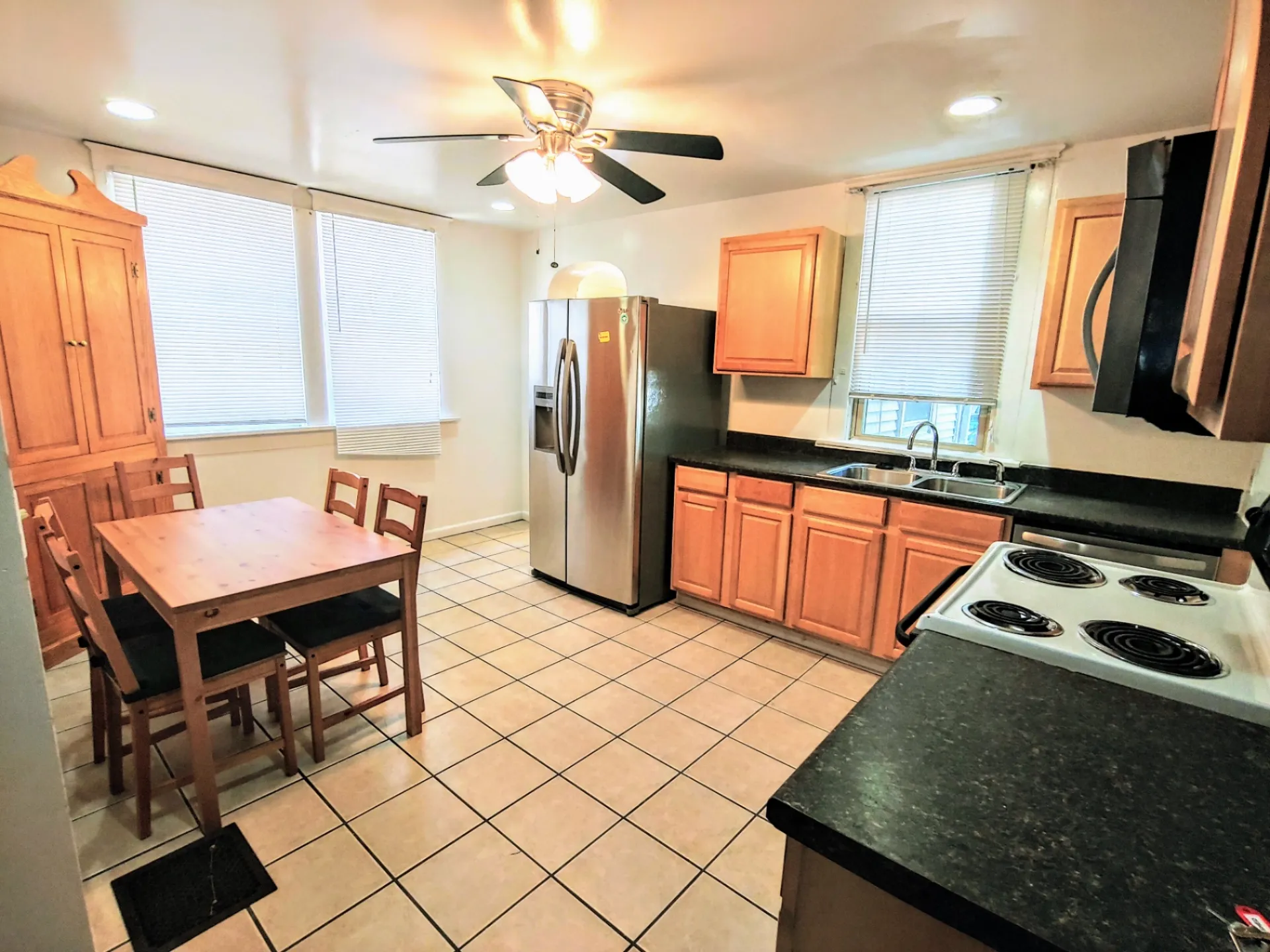 1818 Summit St. eat-in kitchen with stainless fridge, dishwasher, ceiling fan, and dining table