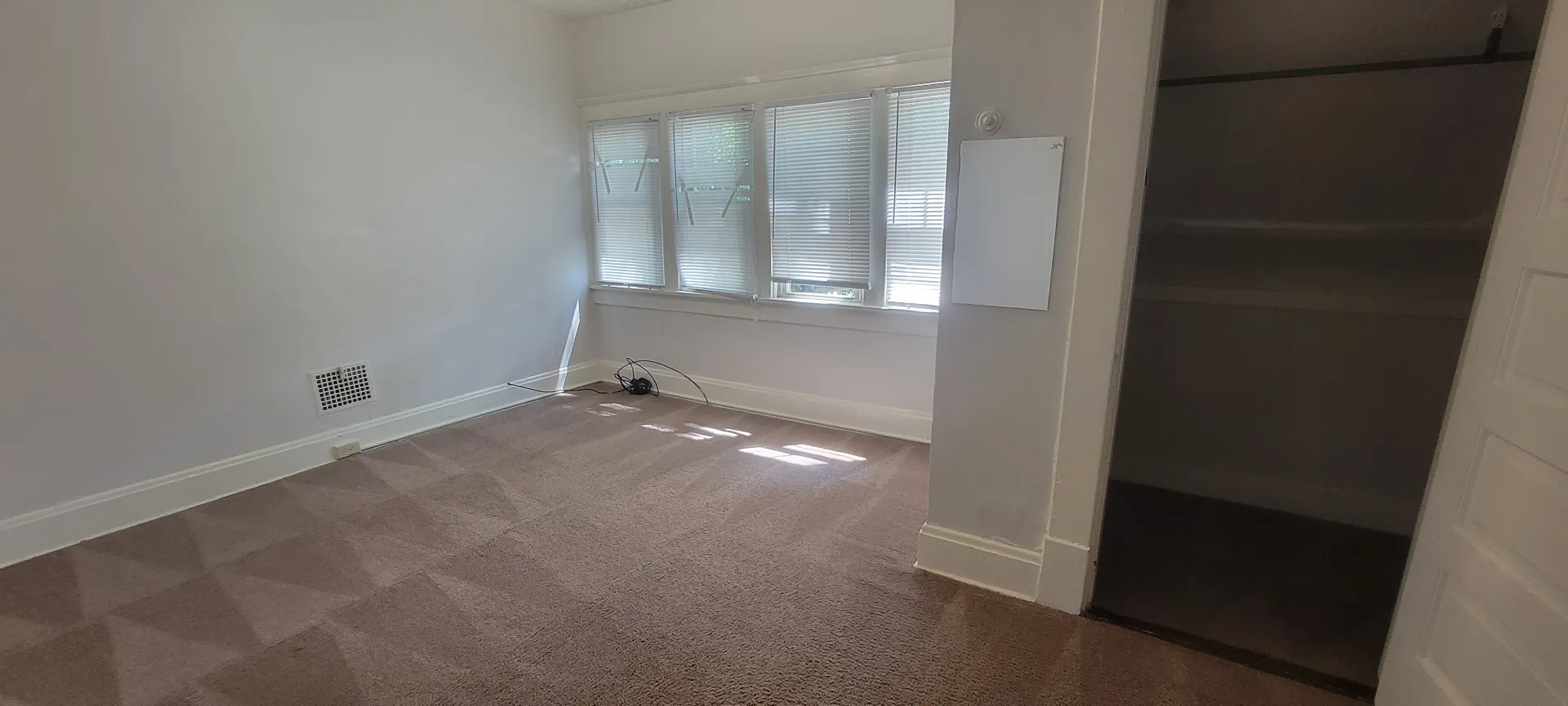 2015 Summit St. carpeted bedroom with bank of windows and sliding barn door closet