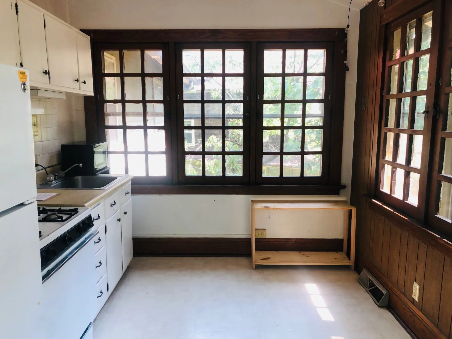 2026 Iuka Ave C kitchen with wide casement windows overlooking the ravine treetops