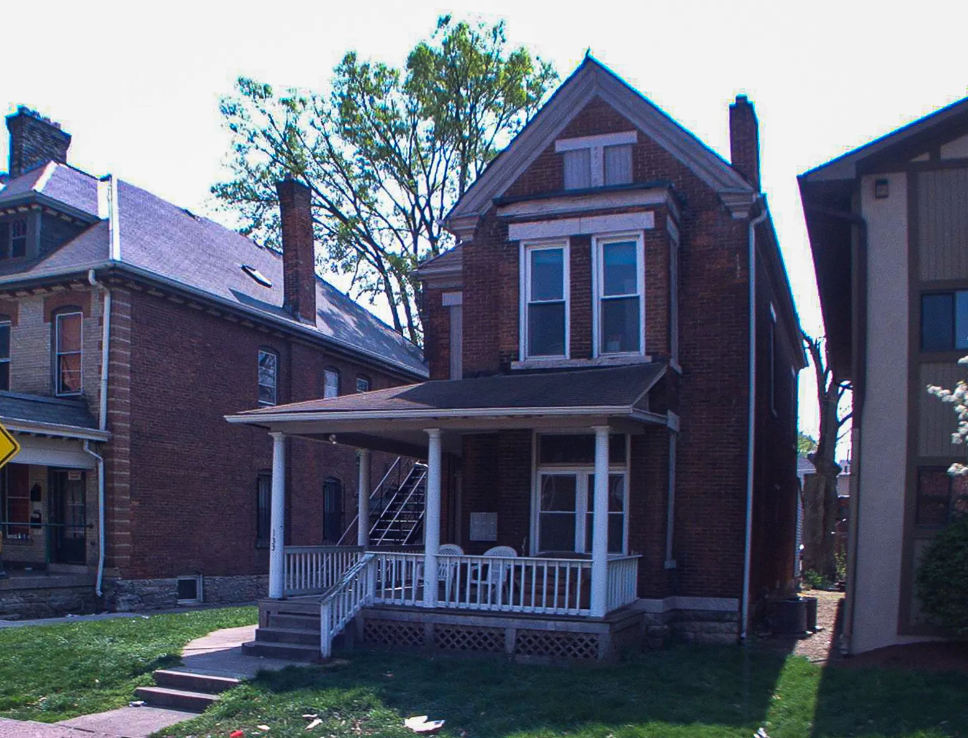 133 W 10th Ave. exterior — brick Victorian with covered front porch