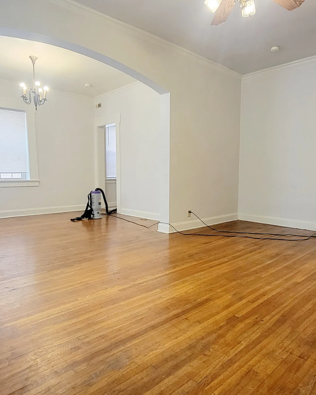 Unit A living and dining space with hardwood floors and ceiling fan