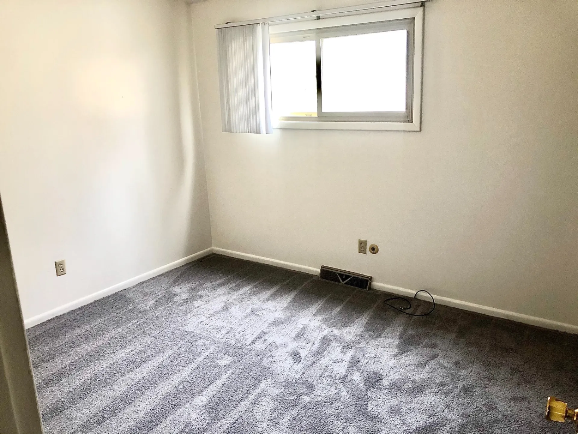2011 Summit St. Unit D second bedroom with fresh gray carpet and bright window