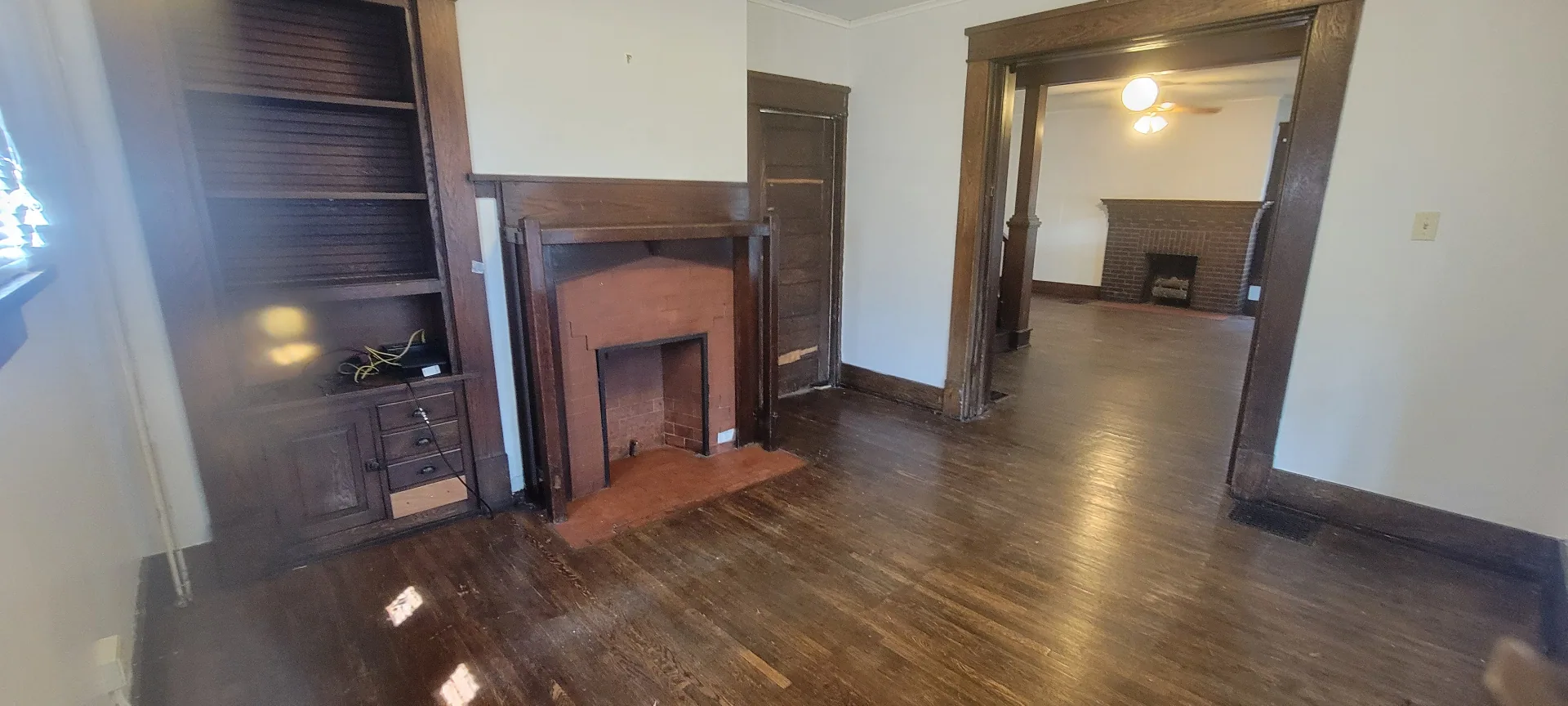 2015 Summit St. front parlor with brick fireplace opening into the main living room