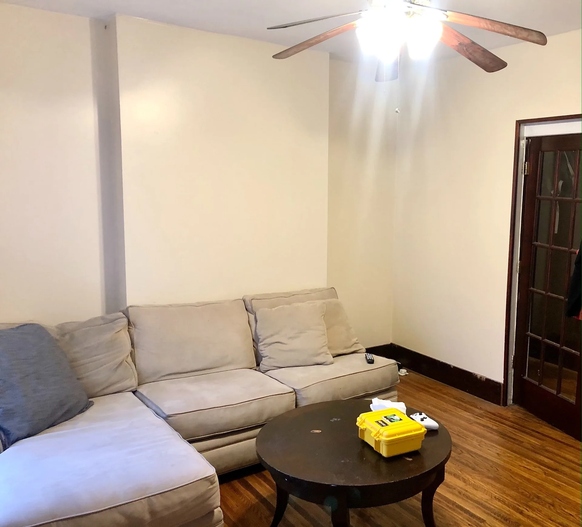 89 E Woodruff Ave. Unit 89 living room with hardwood floors, ceiling fan, and French door to bedroom