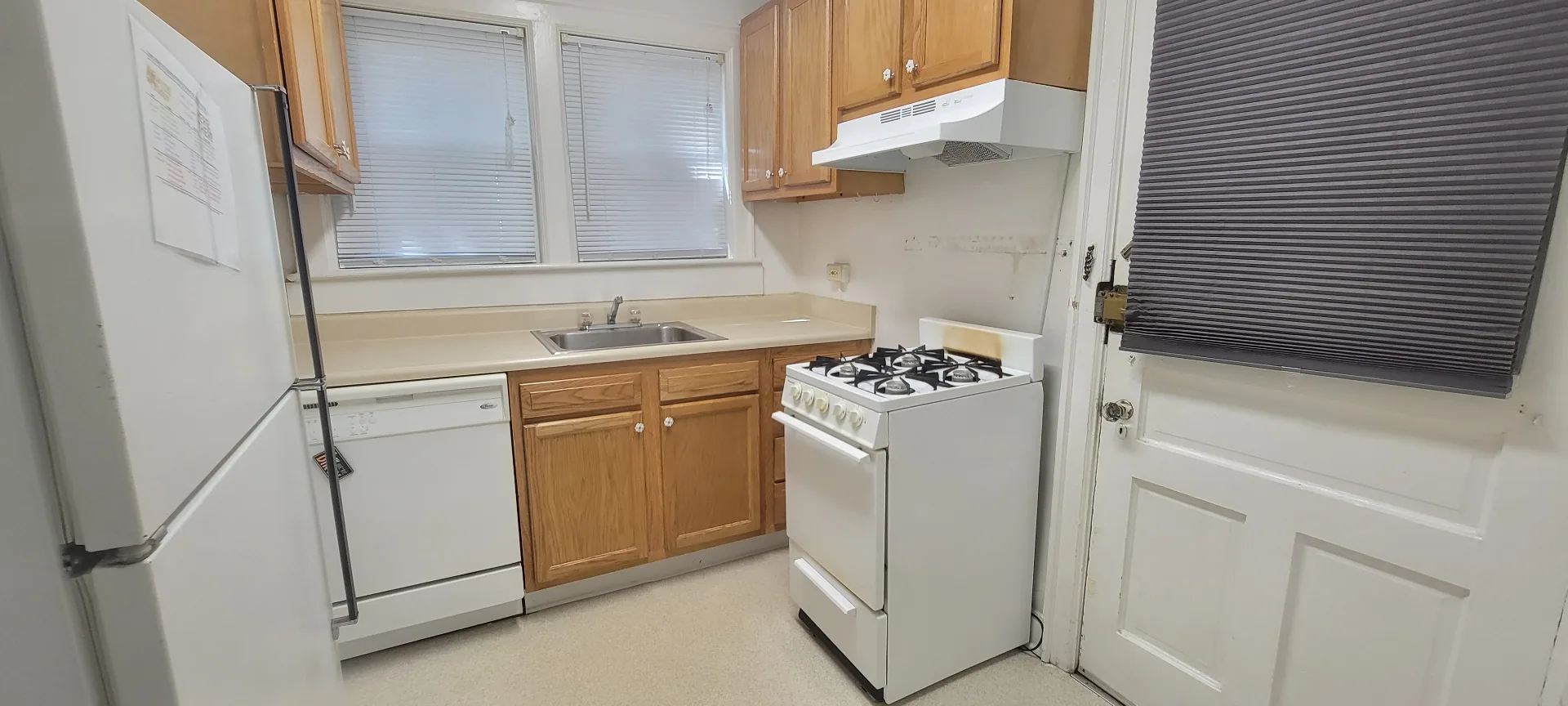 2054 Iuka Ave. A kitchen with oak cabinets, dishwasher, and gas range