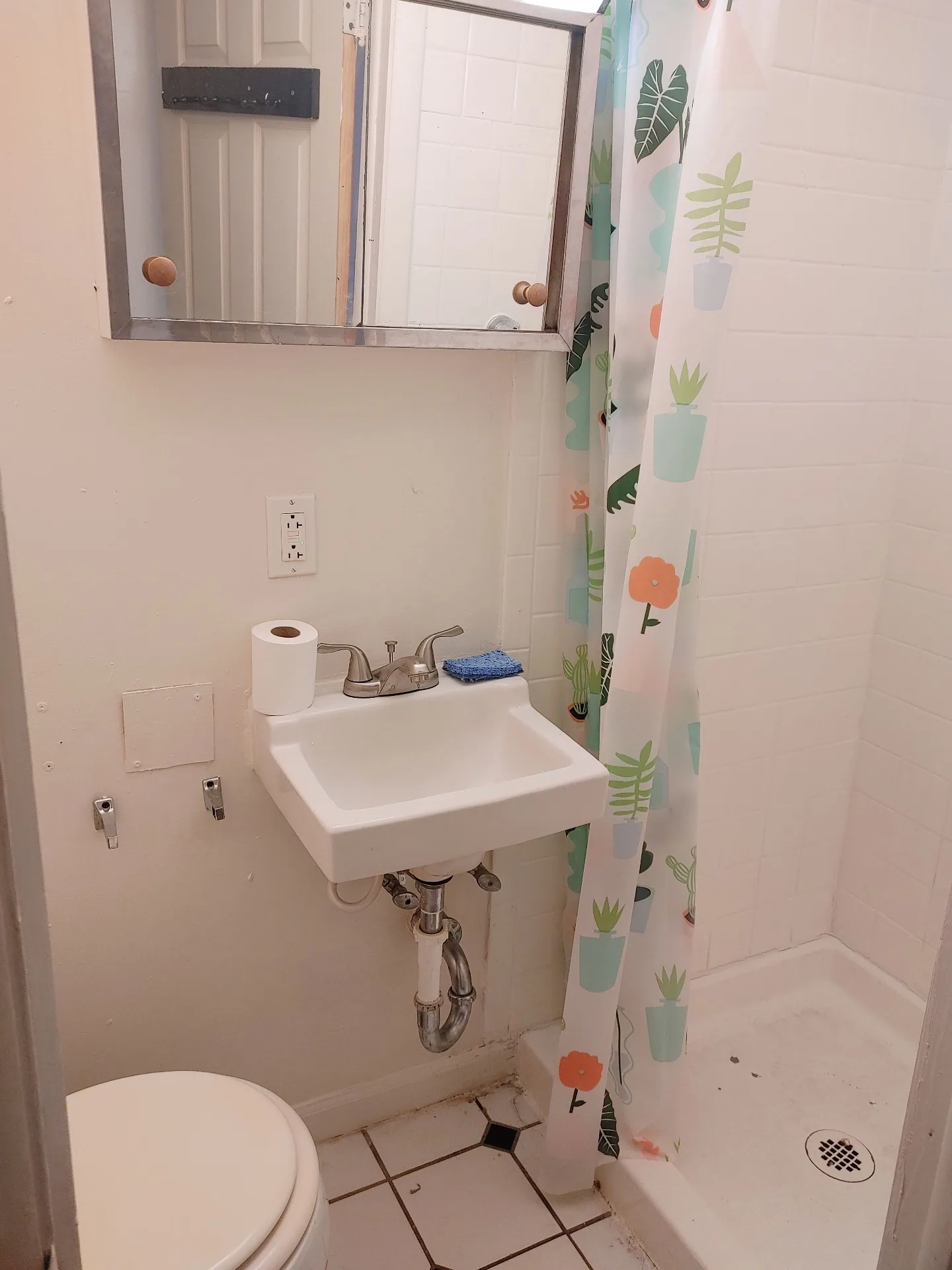 89 E Woodruff Ave. Unit C bathroom with pedestal sink, medicine cabinet, and walk-in tiled shower