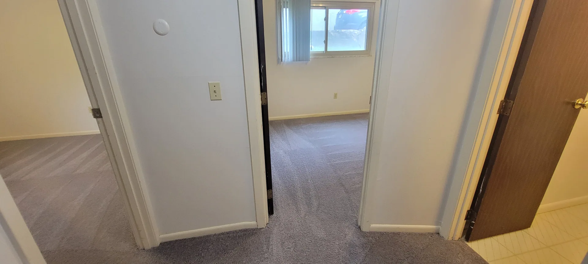 2022 Summit St. upper hallway with fresh carpet and doorways to the bedrooms and bath