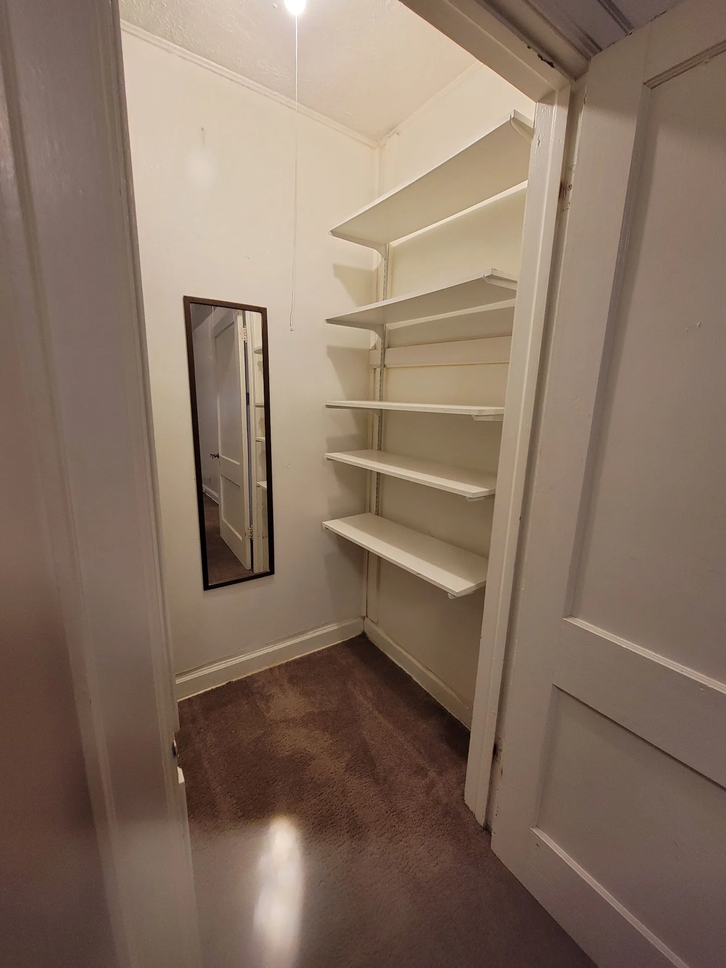 2048 Iuka Ave. B storage closet with built-in shelving and mirror
