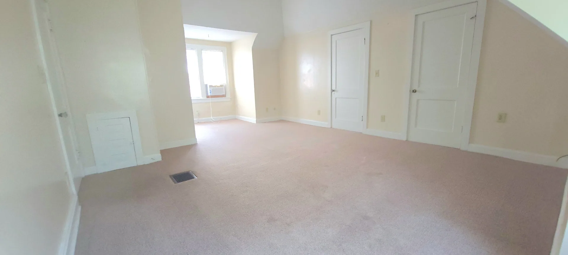 2054 Iuka Ave. C broad bedroom layout with soft natural light and expansive floor space