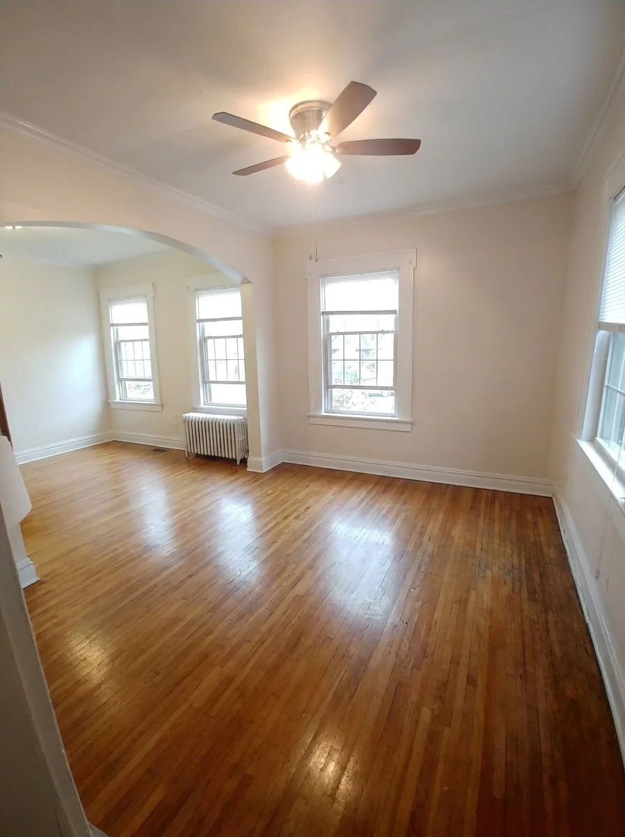 Unit C dining room with archway opening and radiator