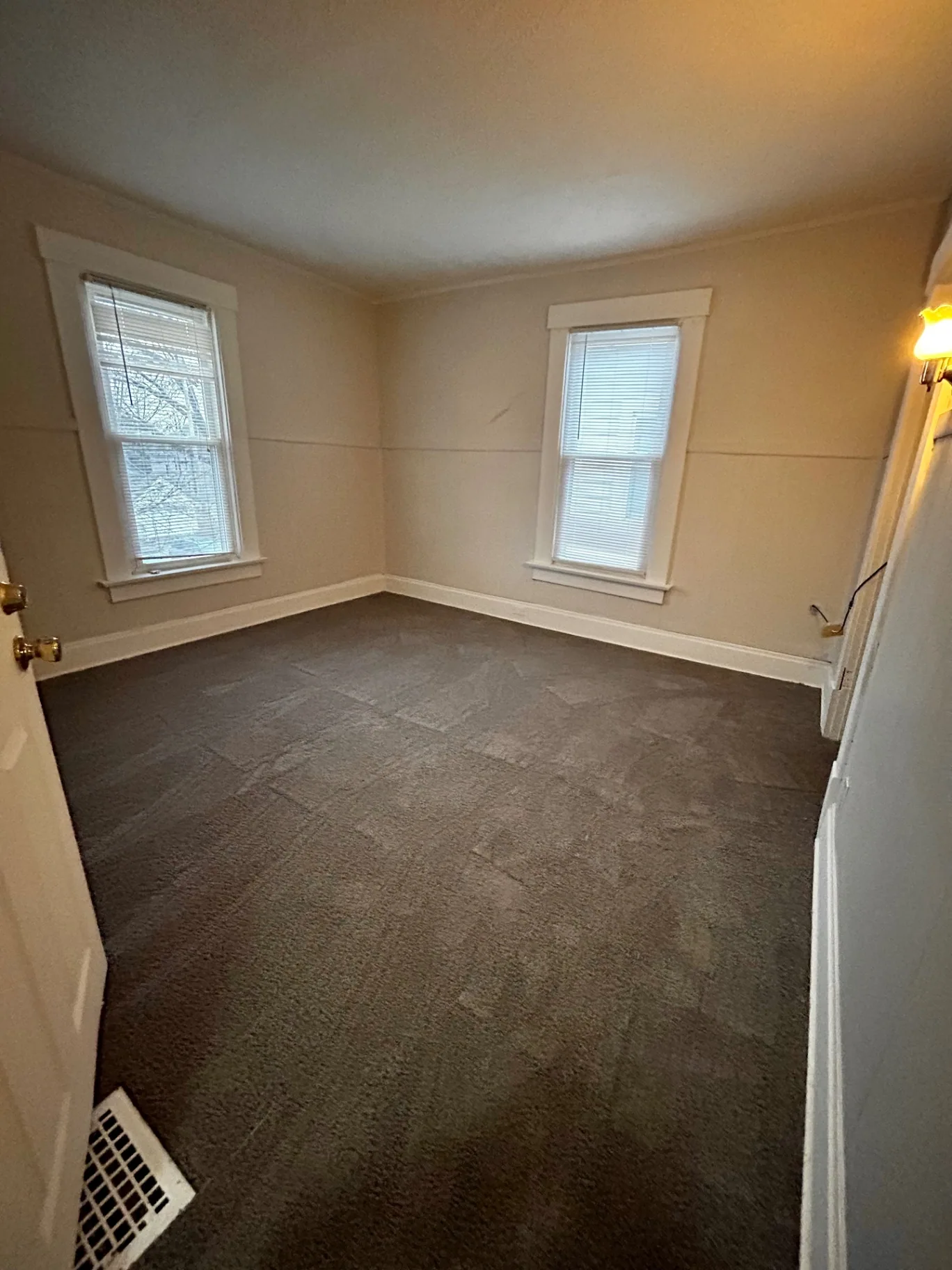 68 E Patterson Ave. carpeted bedroom with two windows and wall sconce