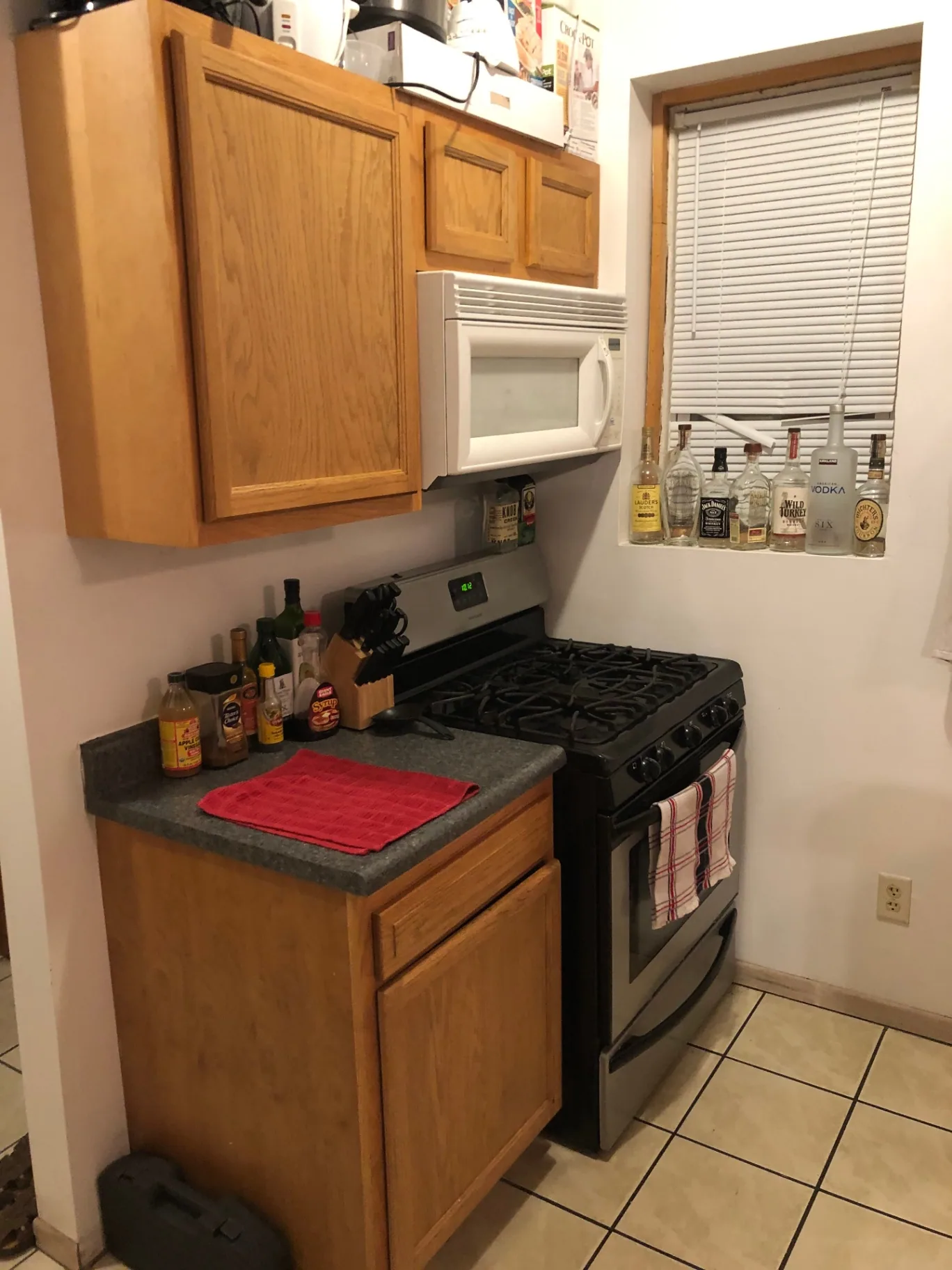 77 E Patterson Ave. kitchen with gas range, oak cabinets, and built-in microwave
