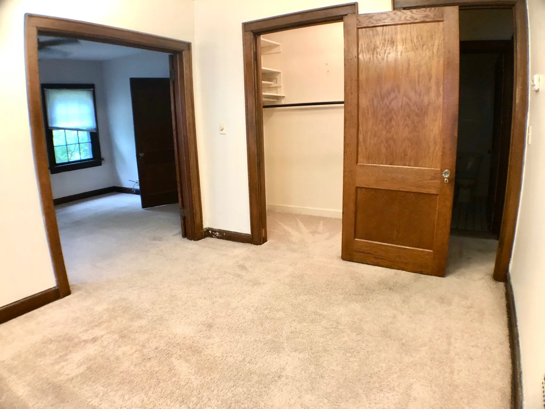 2054 Iuka Ave. D interior hallway with original wood doors, walk-in closet, and view into bedroom