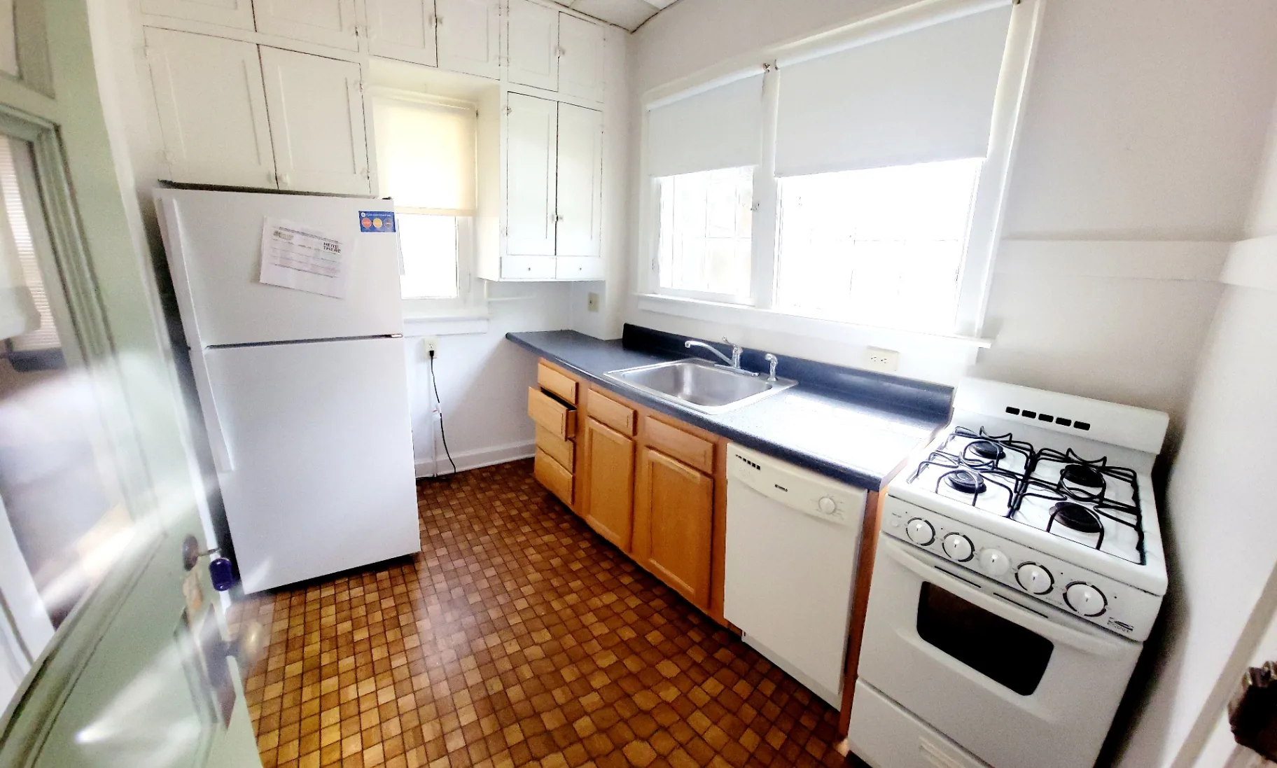 2048 Iuka Ave. A kitchen with white appliances, dishwasher, and wraparound counter space