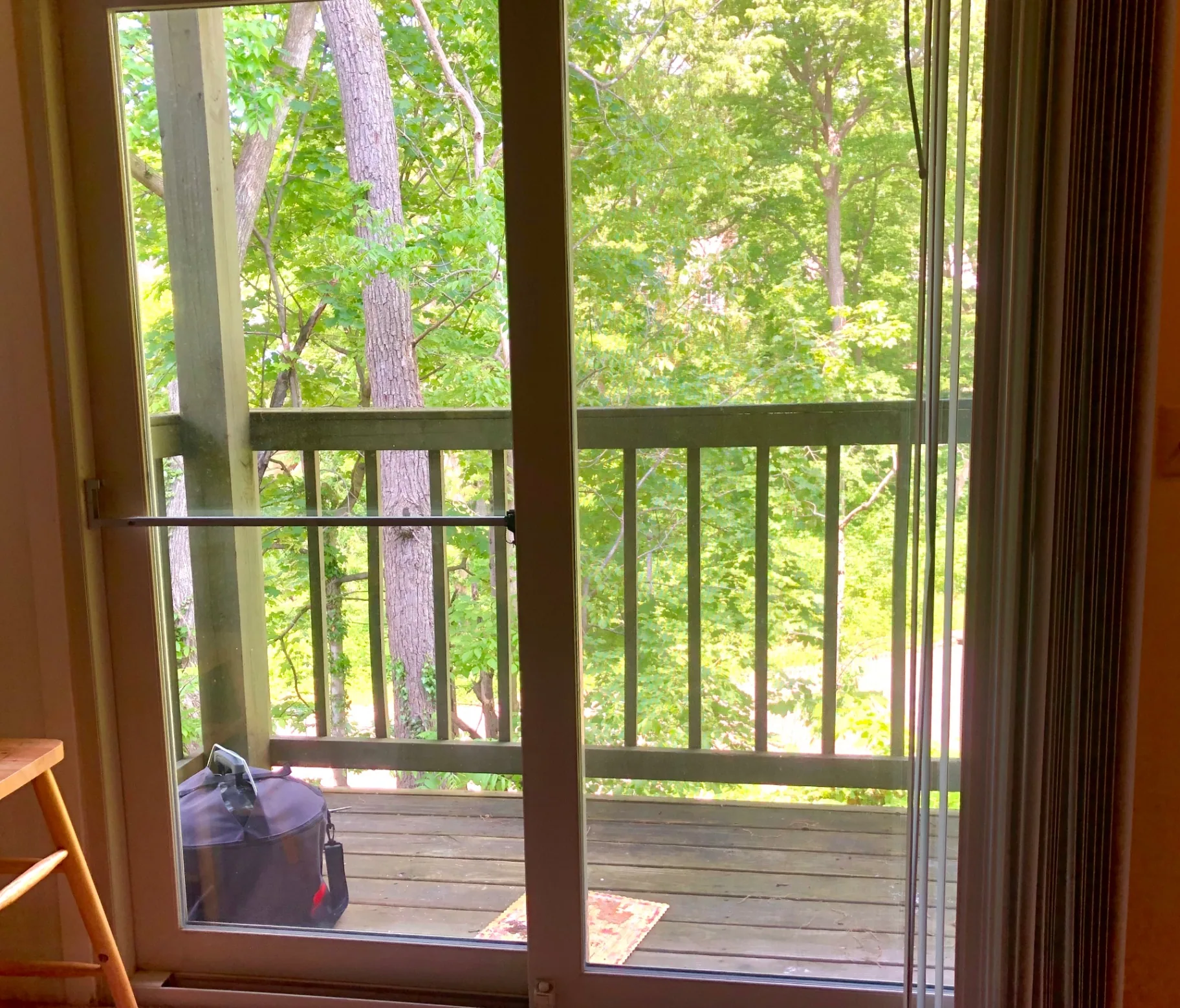 2022 Summit St. sliding door opening to a private balcony framed by mature leafy trees