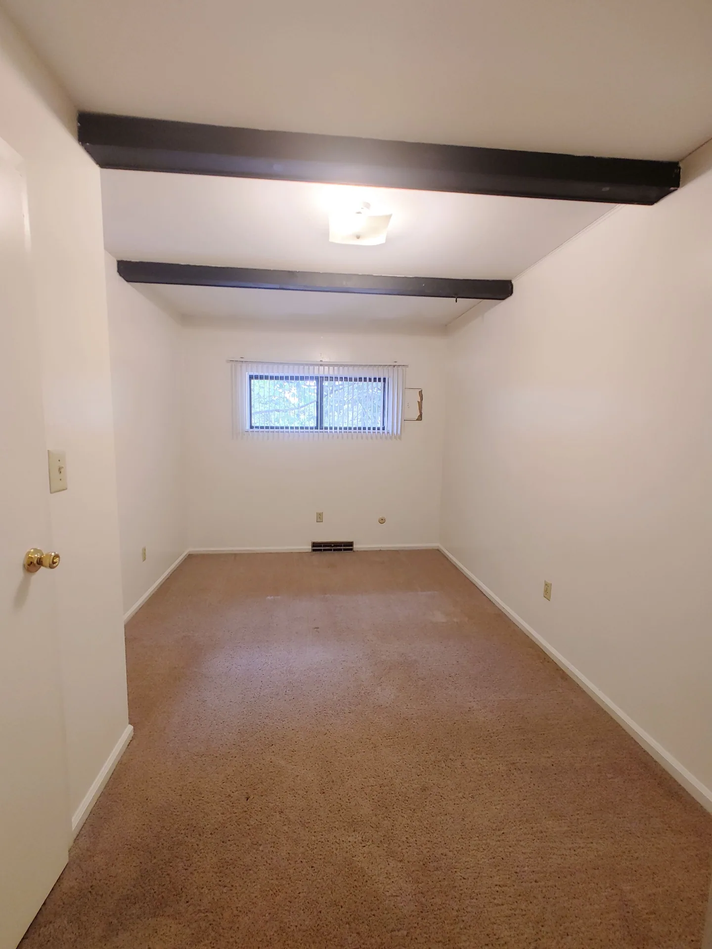 2020 Iuka Ave. bedroom with exposed dark ceiling beams, fresh carpet, and window with blinds