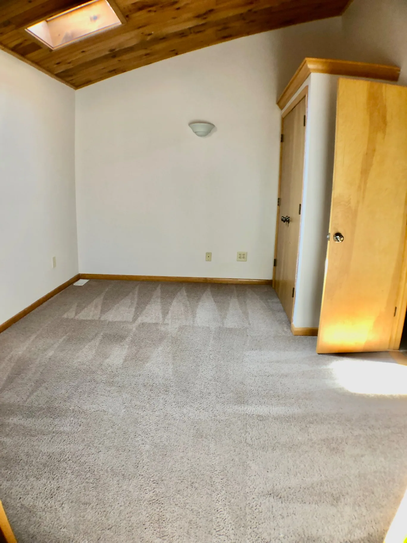 2040 Iuka Ave House bedroom with skylight, vaulted wood ceiling, and closet