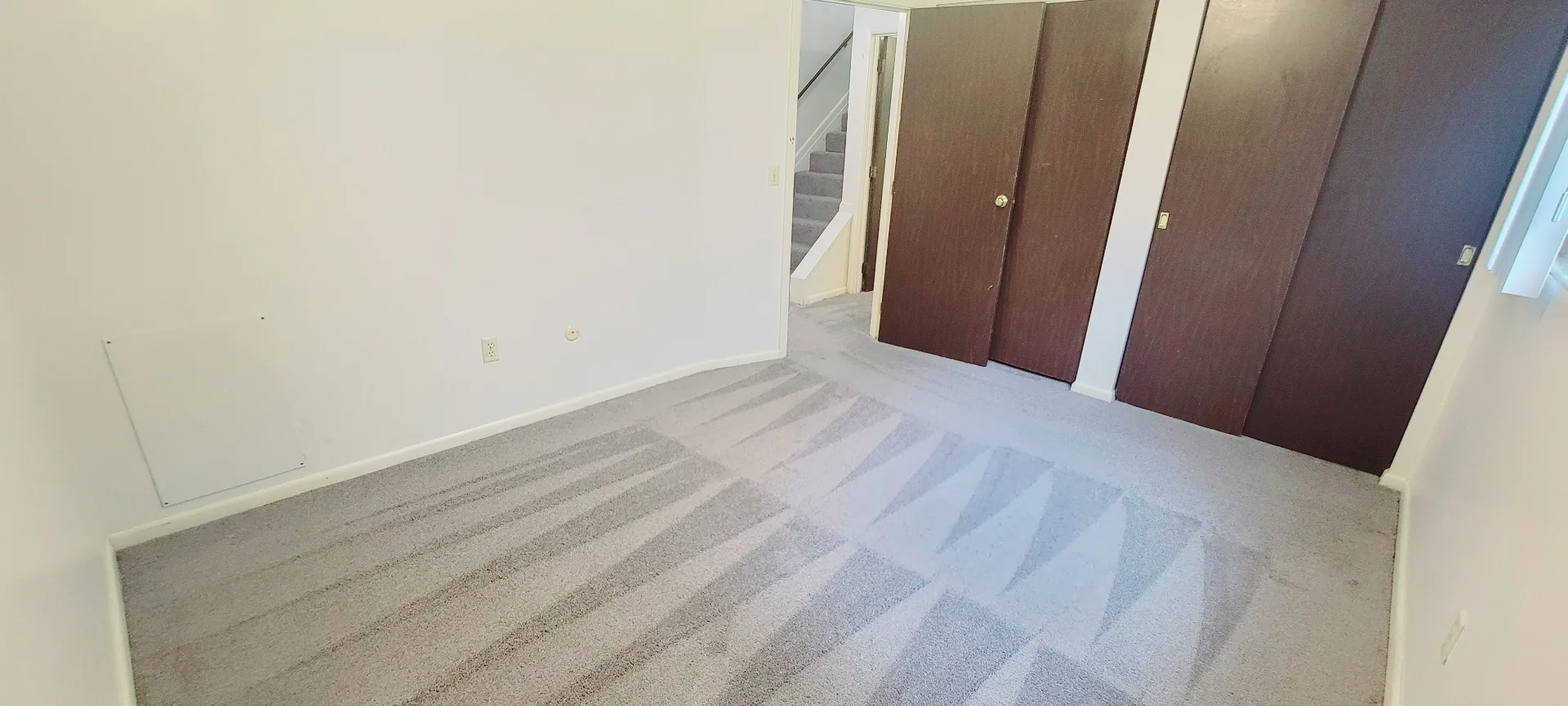2024 Summit St. bedroom with double closet doors and soft gray carpet
