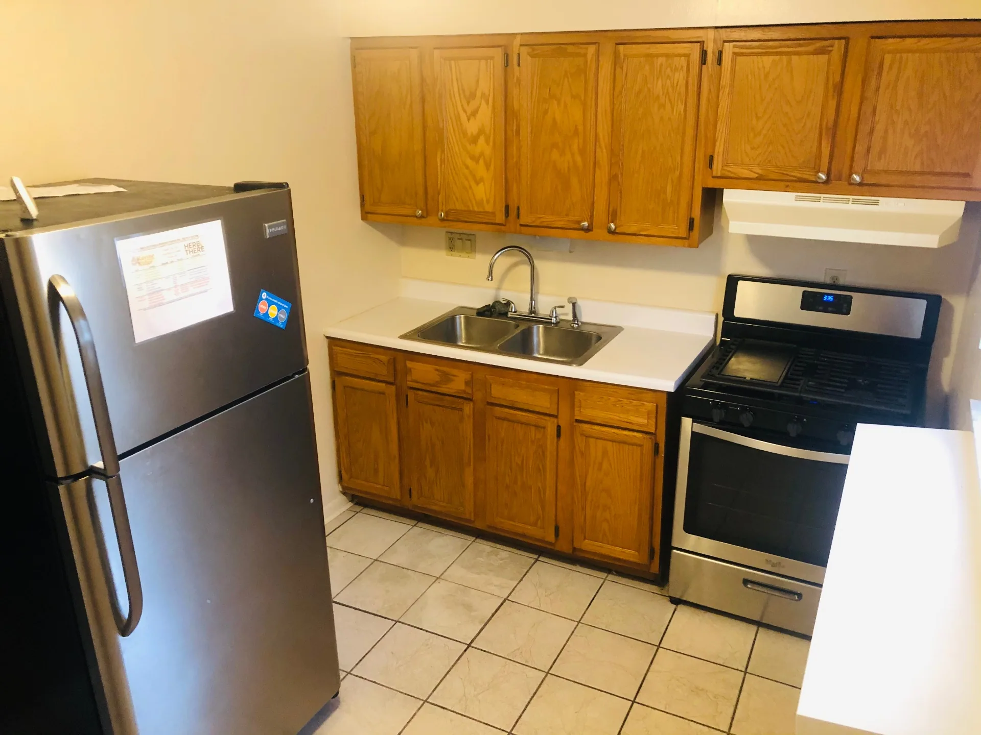 2150 N 4th St. Unit A kitchen with stainless fridge, double sink, and tile floor