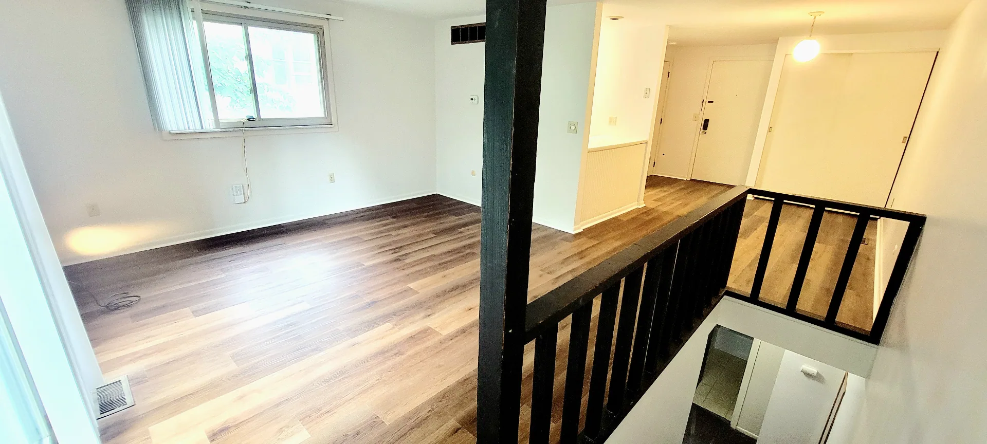2024 Summit St. bedroom with large windows, wood-look plank floors, and bright natural light