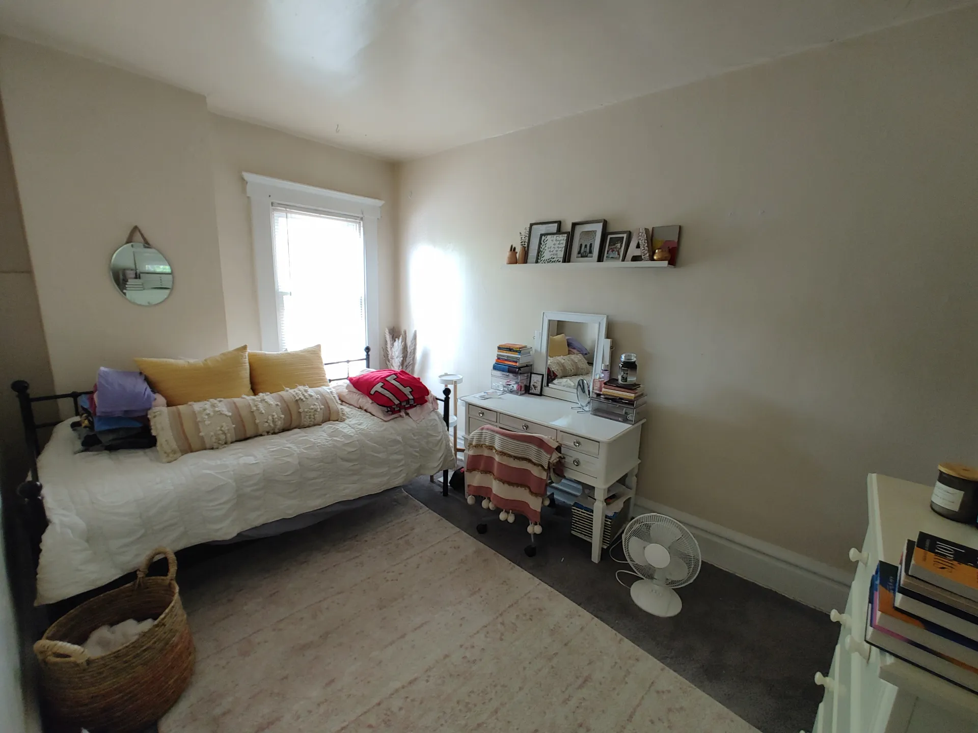 121 W 9th second bedroom with daybed, area rug, and vanity