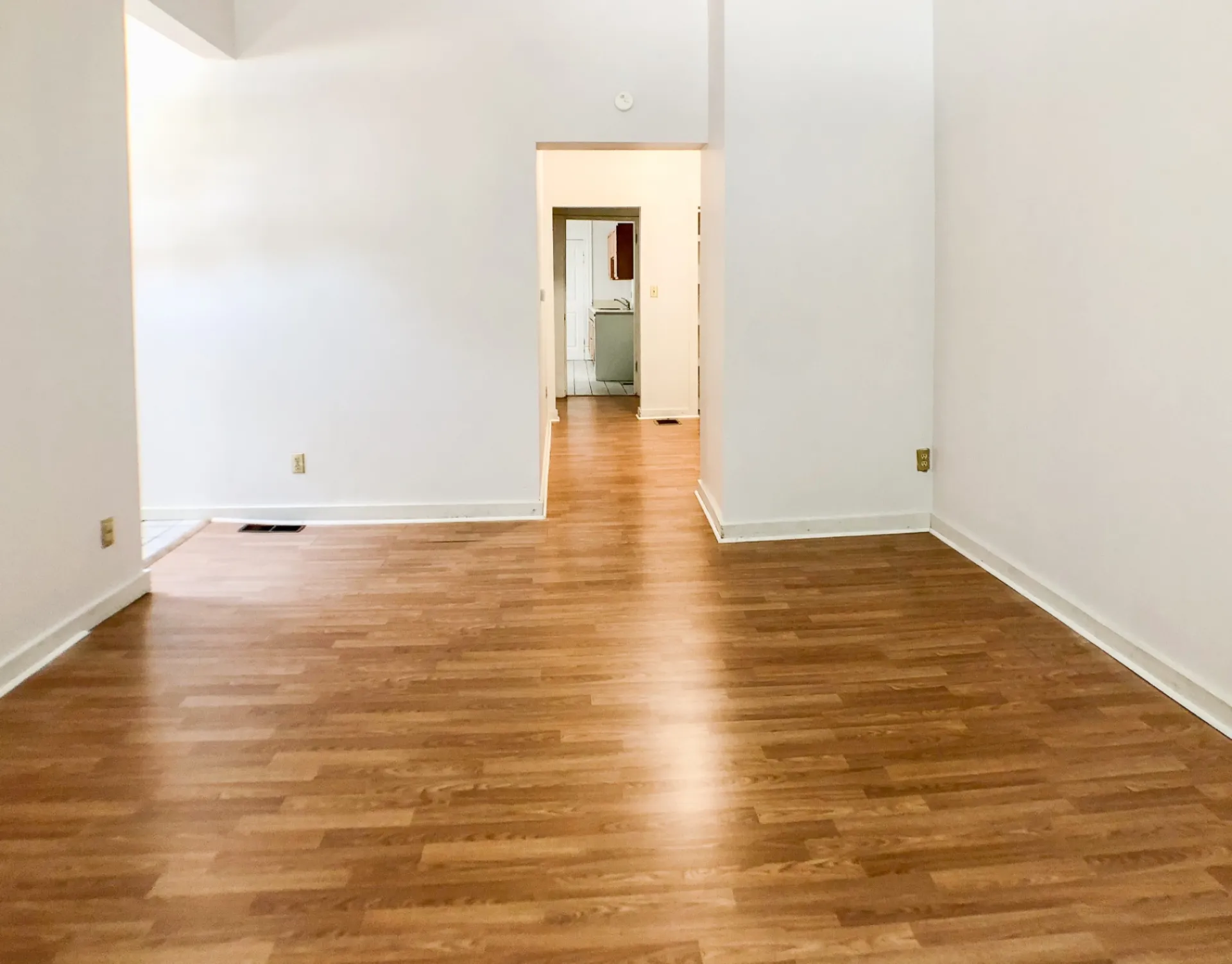 Unit A open living space looking down the hallway toward the kitchen