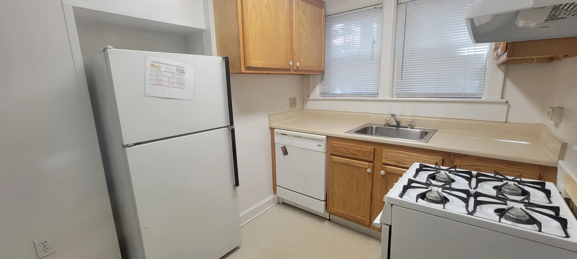 2054 Iuka Ave. A kitchen with full-size refrigerator, dishwasher, and bright windows