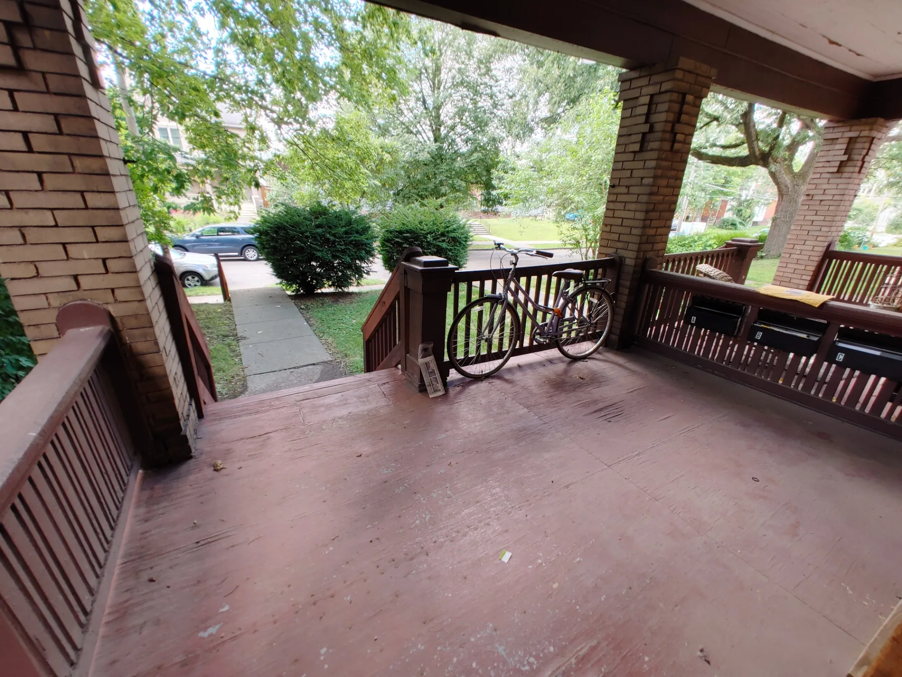 374 A E 14th Ave. wide view of the shared front porch with tree-lined street beyond