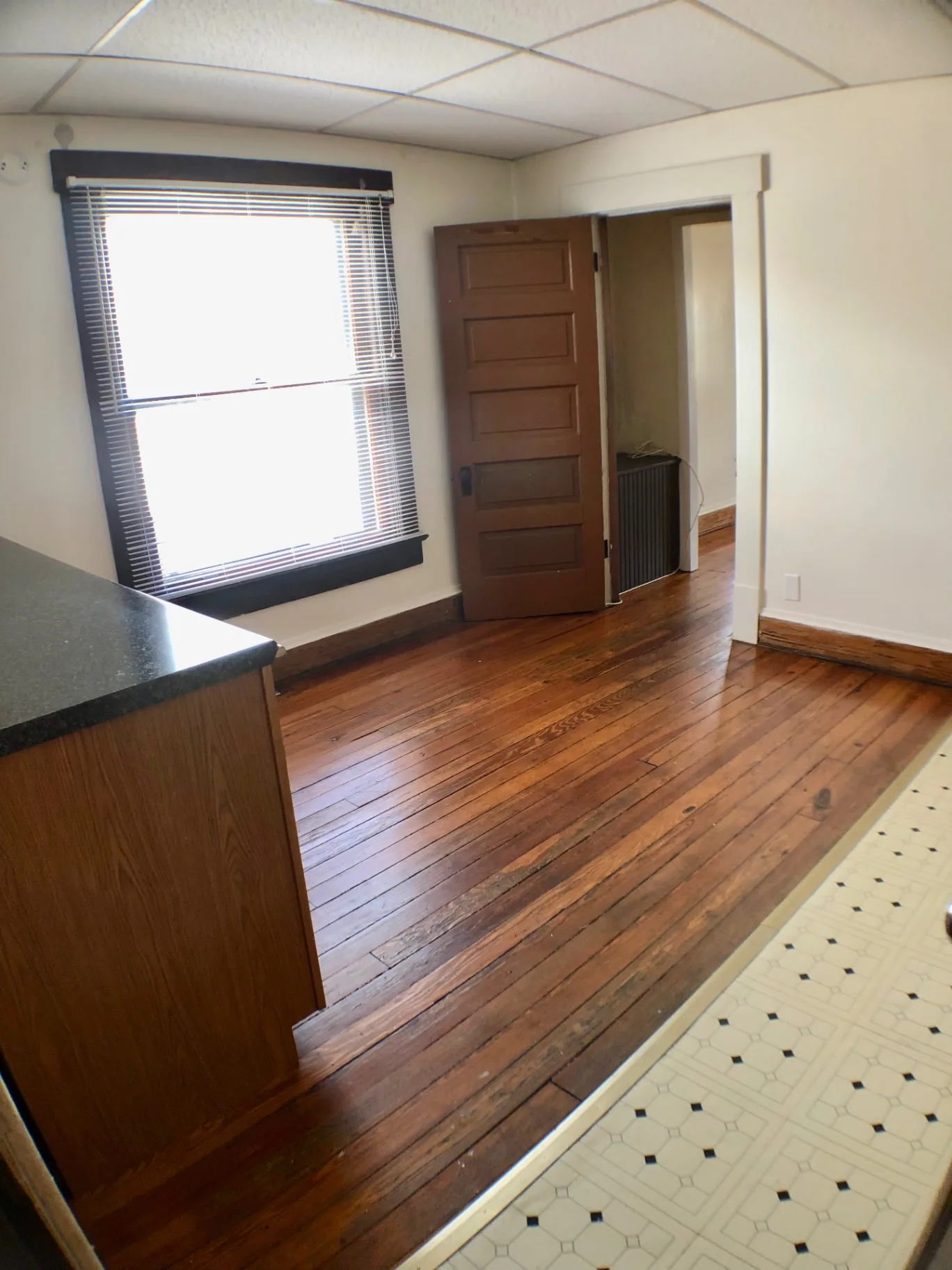 89 E Woodruff Ave. Unit A kitchen entry with hardwood floors transitioning to tile