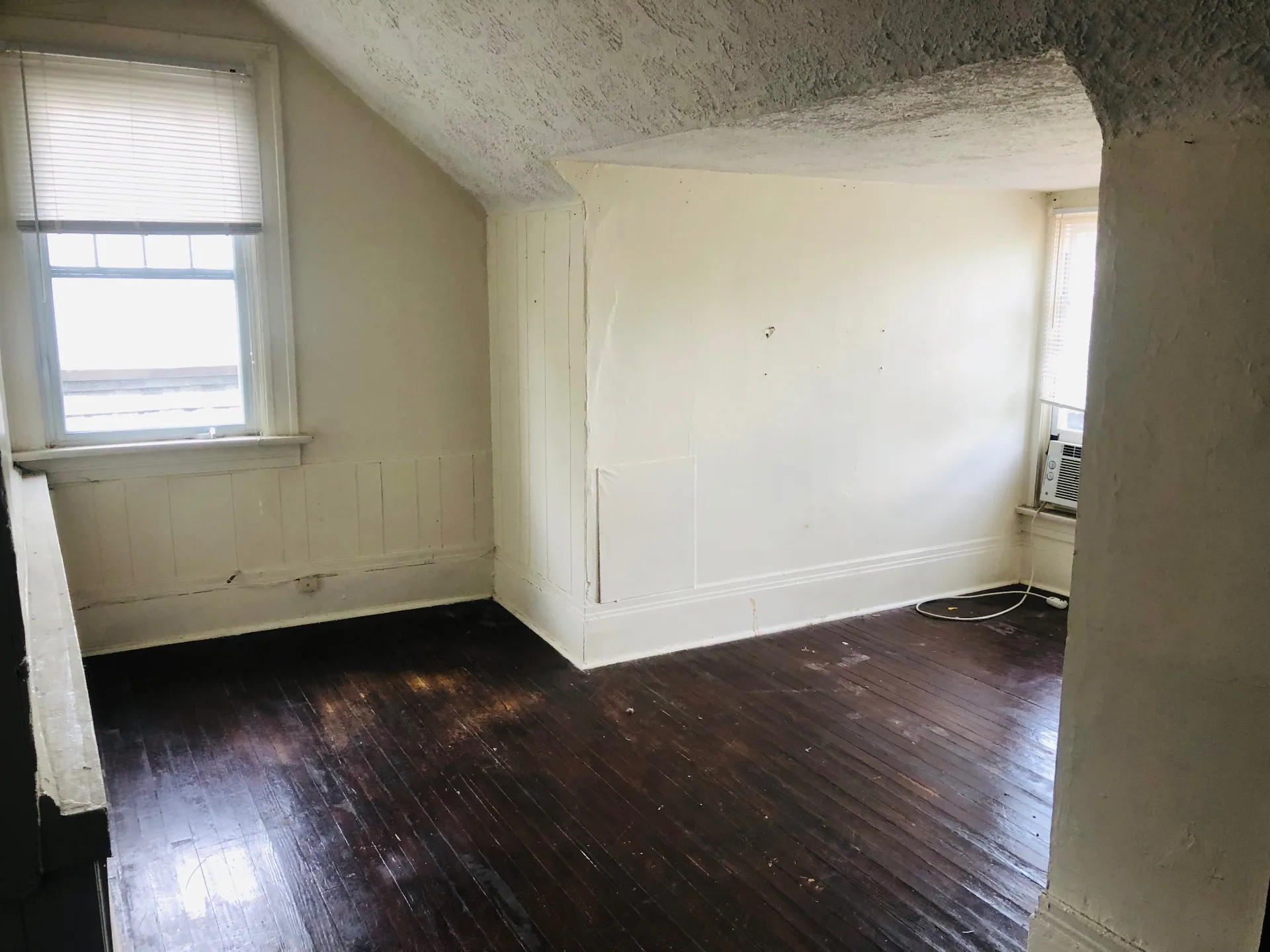 2005 Summit St. upper-level bedroom with vaulted ceiling, wainscoting, and window AC