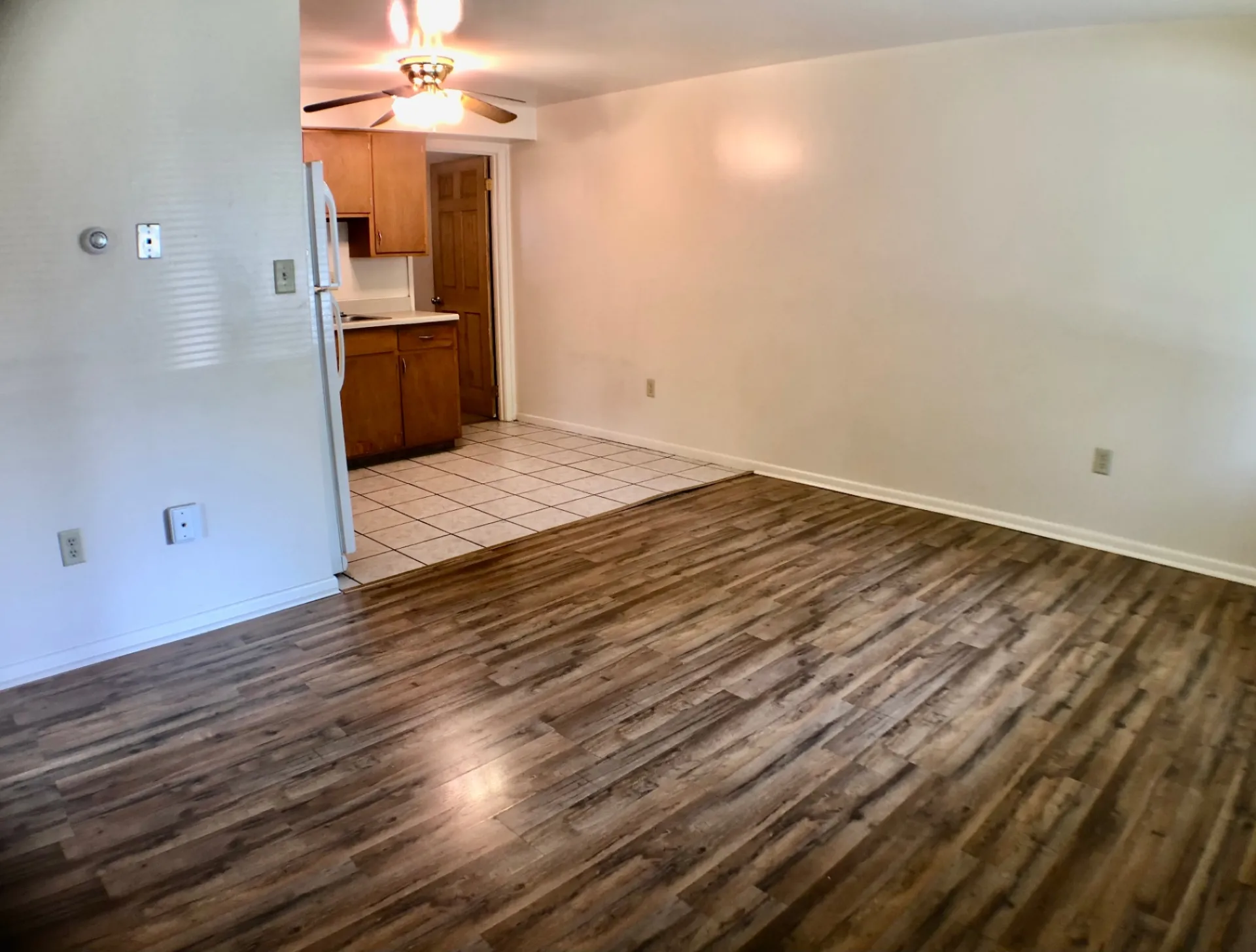 1827 N 4th St. Unit 1 living area opening to tile kitchen with ceiling fan