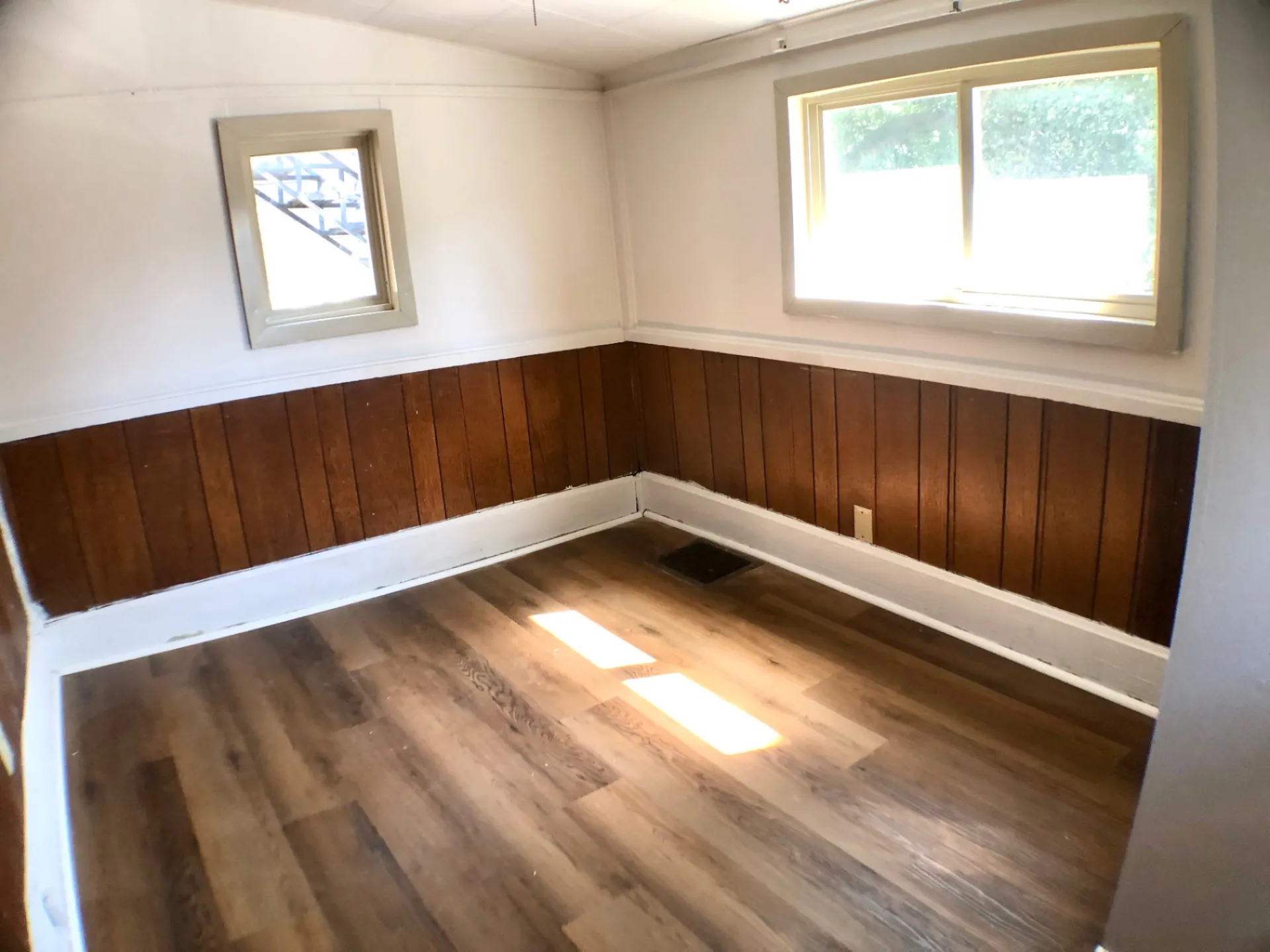 1814 Summit St. bonus room with wood wainscoting, dual windows, and vinyl plank floor