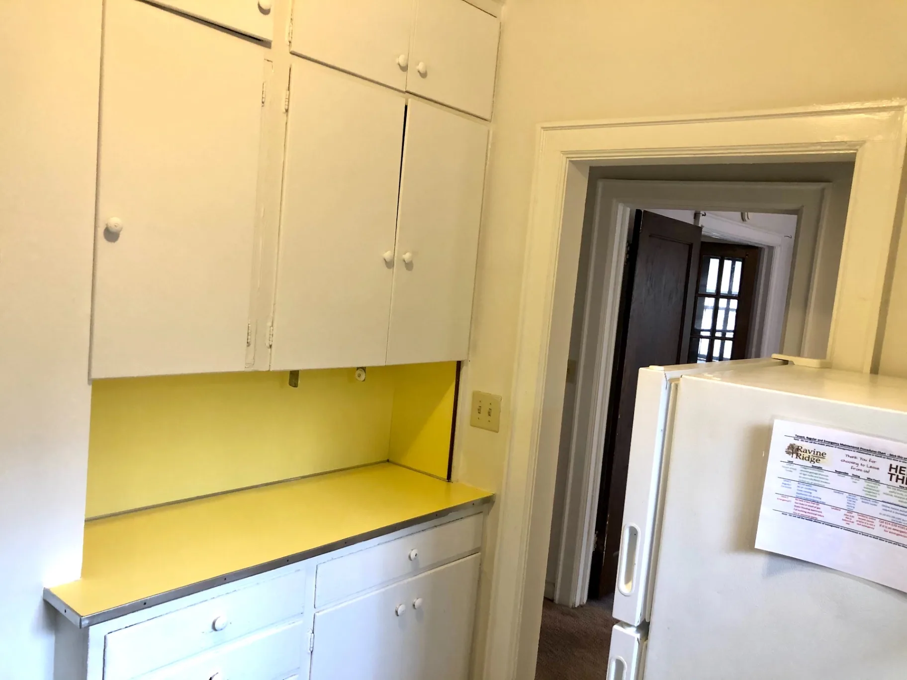 2044 Iuka Ave. B kitchen with ample white cabinet storage and full-size refrigerator