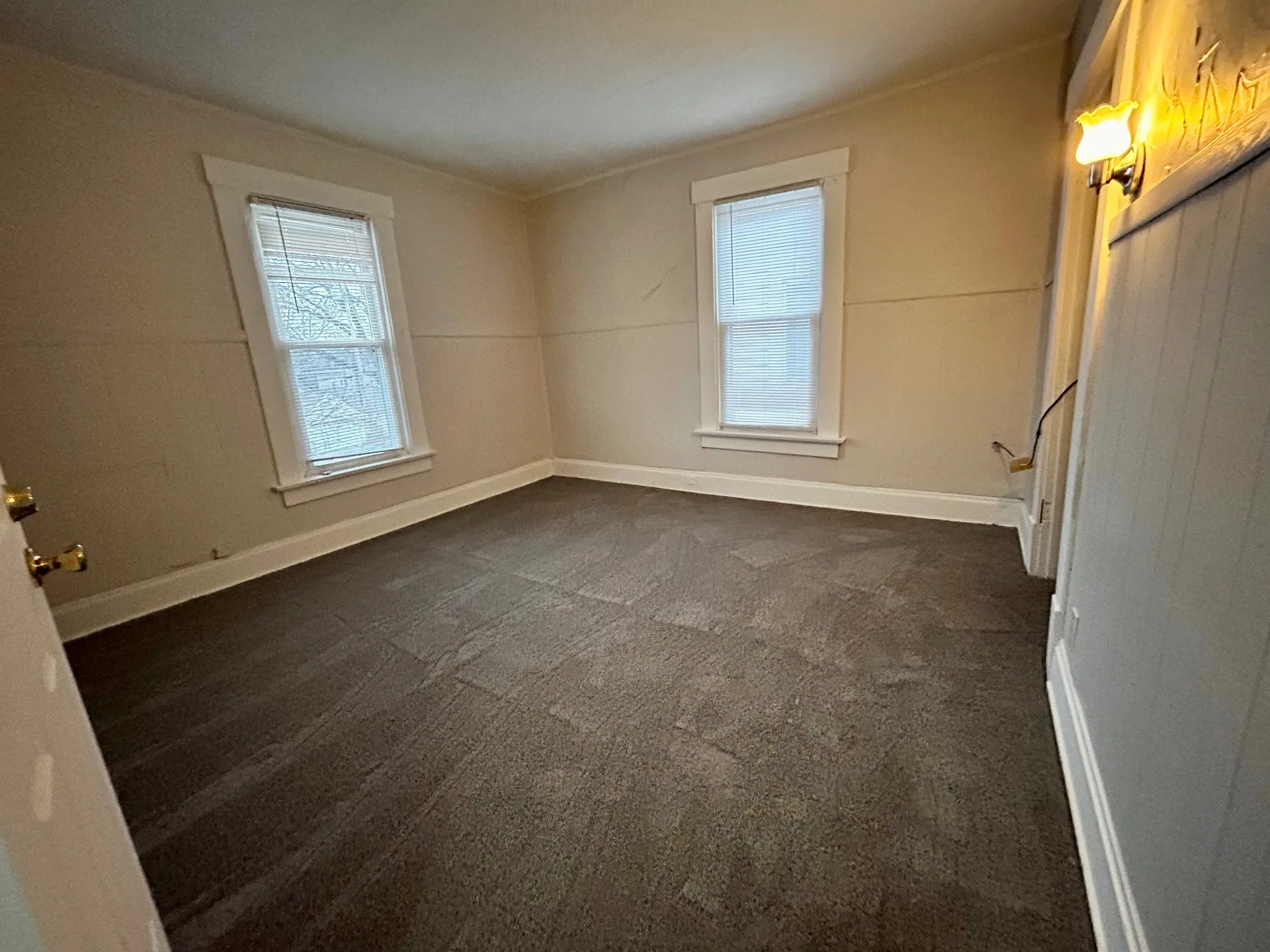 68 E Patterson Ave. carpeted bedroom with two bright windows and wall sconce