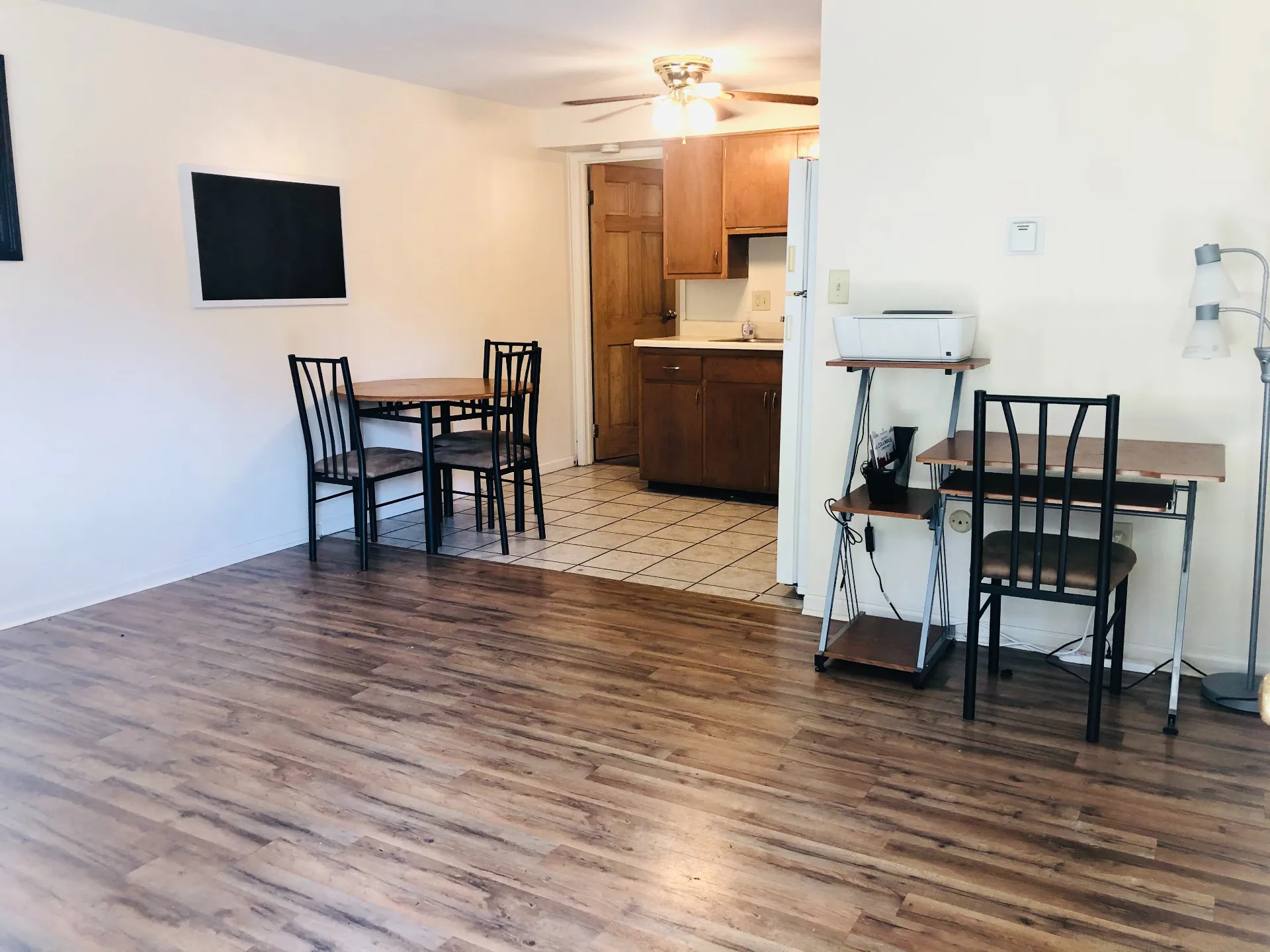 1827 N 4th St. Unit 2 living area with wood-look flooring, ceiling fan, and open tile kitchen