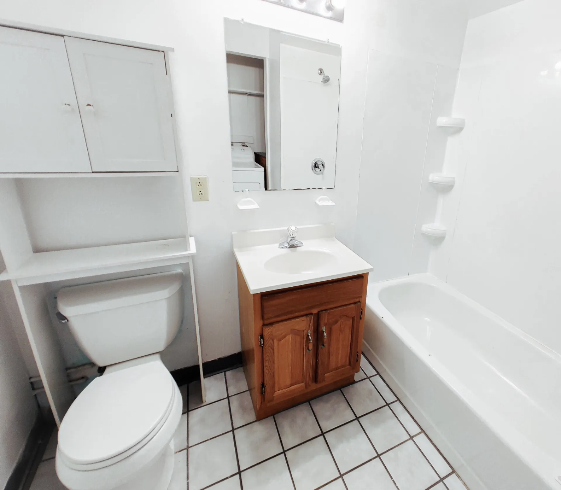 Rear unit bathroom with tub/shower, vanity and storage cabinets
