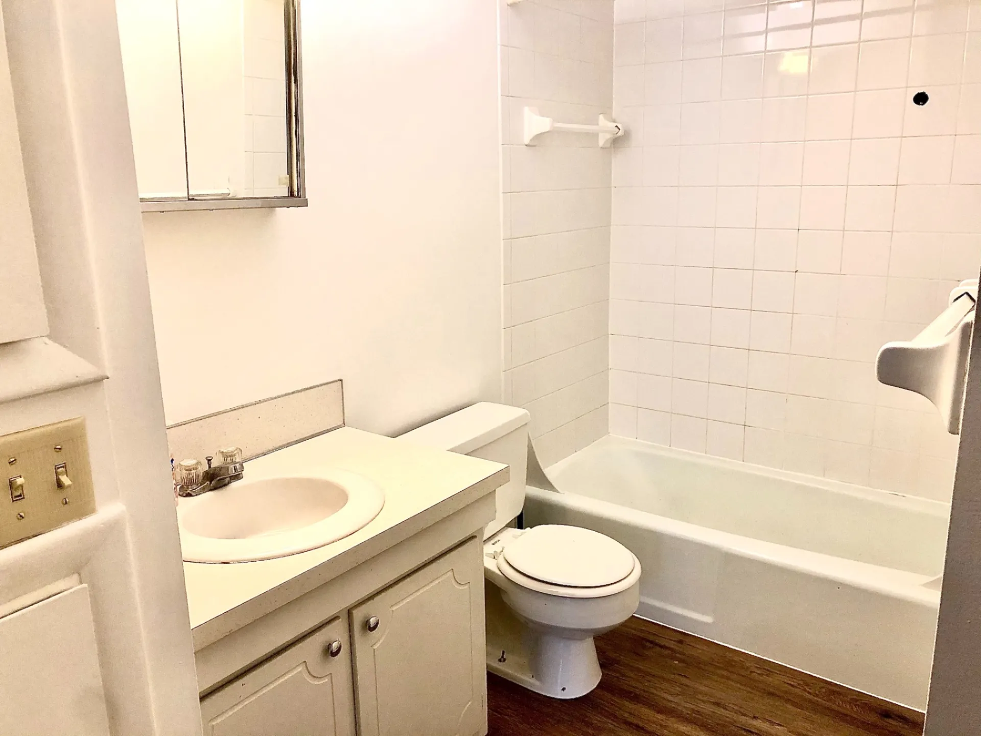 2011 Summit St. Unit B full bathroom with tub/shower, white tile, and vanity