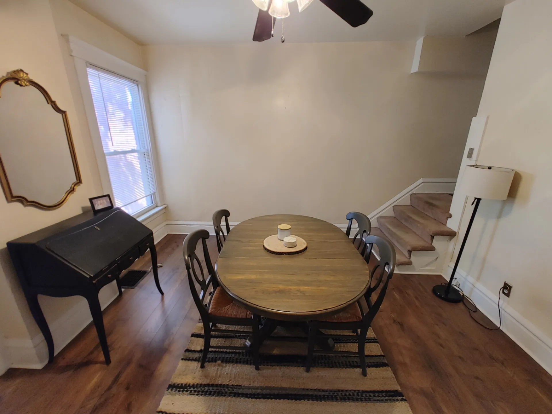 117 W 9th dining area with oval wood table and antique writing desk