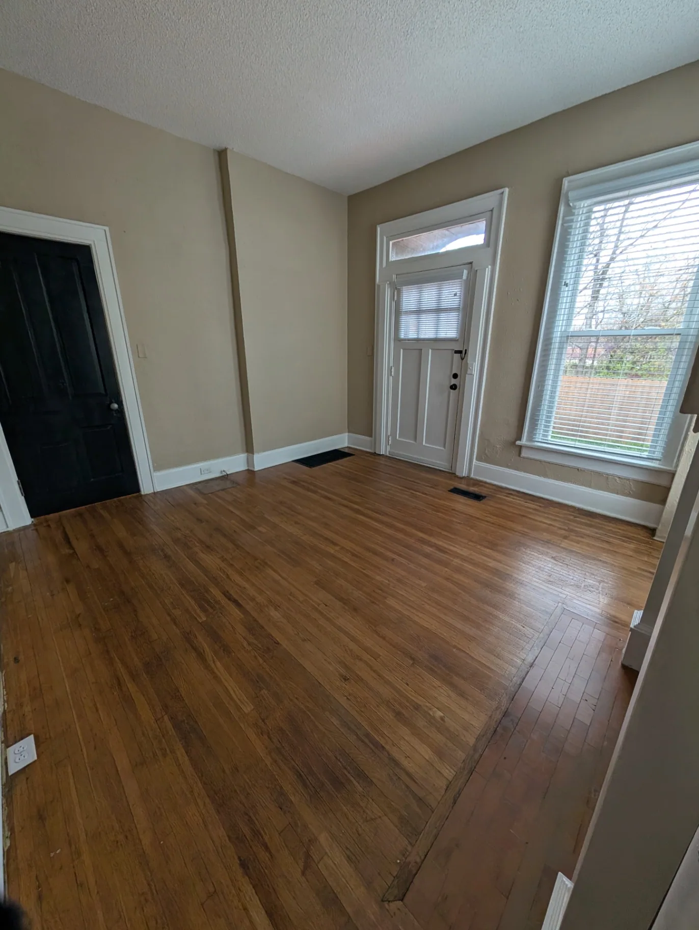 3338 Chestnut Downstairs entry foyer with hardwood floors and side door