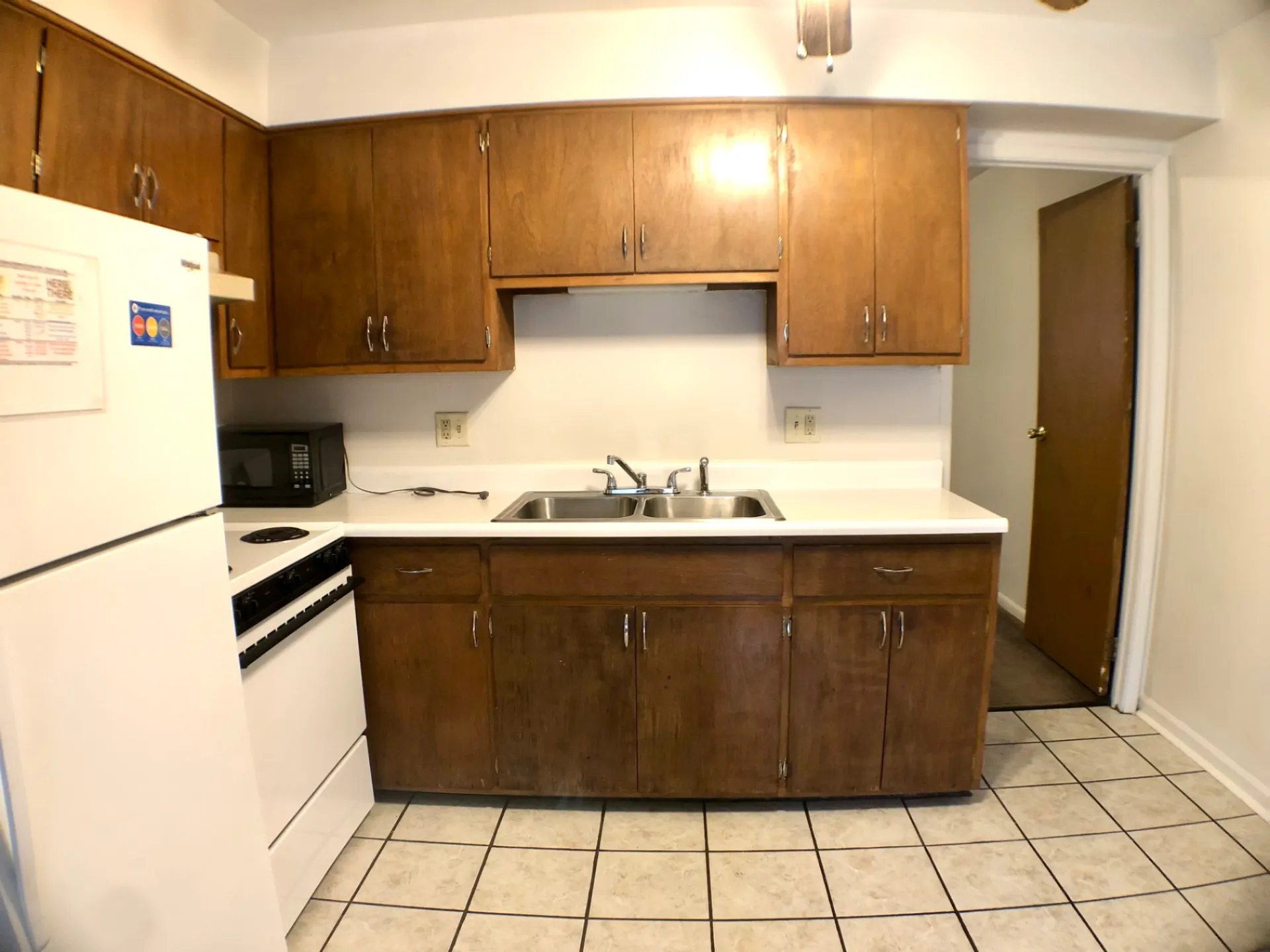 1827 N 4th St. Unit 4 kitchen view with double sink, dishwasher, and oak cabinetry