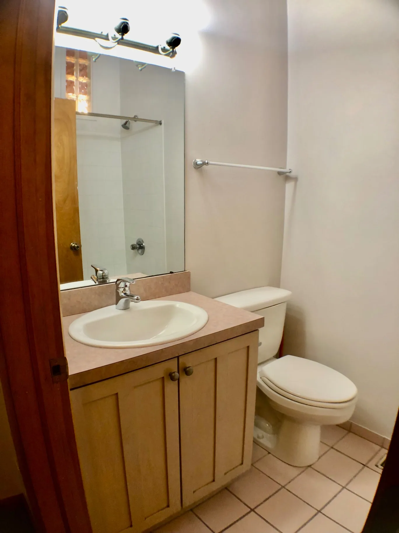 2040 Iuka Ave House bathroom with wood vanity, mirror, and tile floor