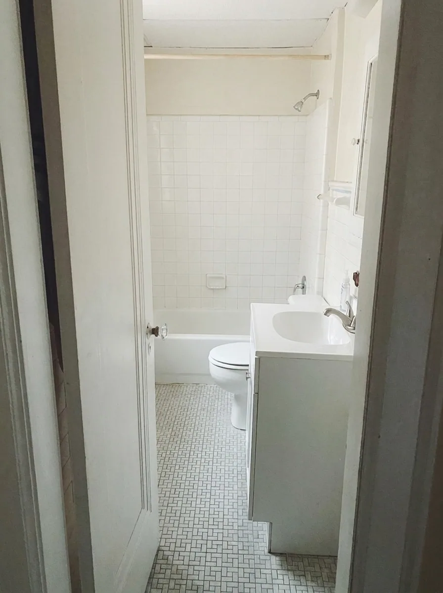 Unit H bathroom with white subway tile shower, tub, and mosaic tile floor