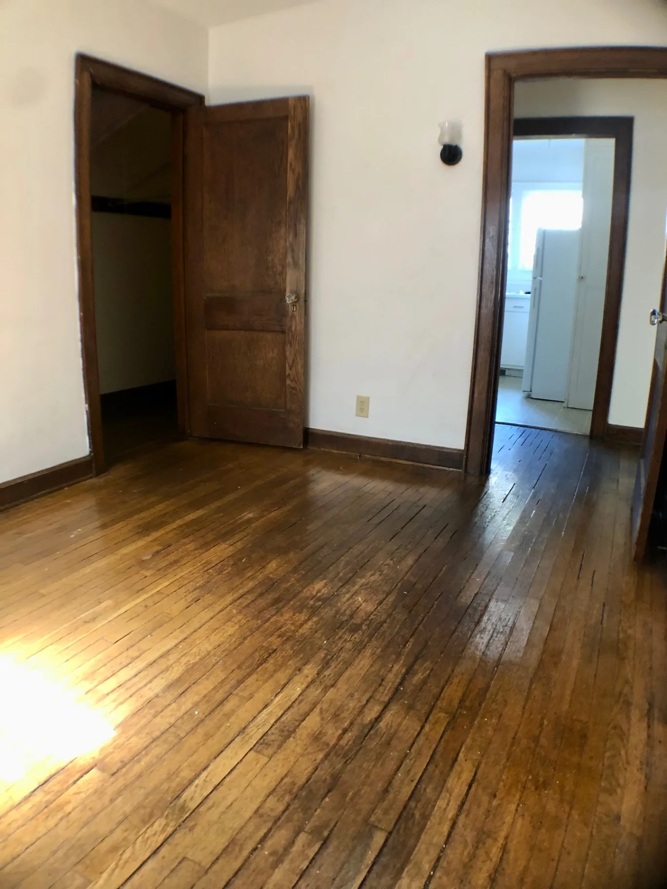 2044 Iuka Ave. A bedroom with hardwood floors, original wood trim, and closet