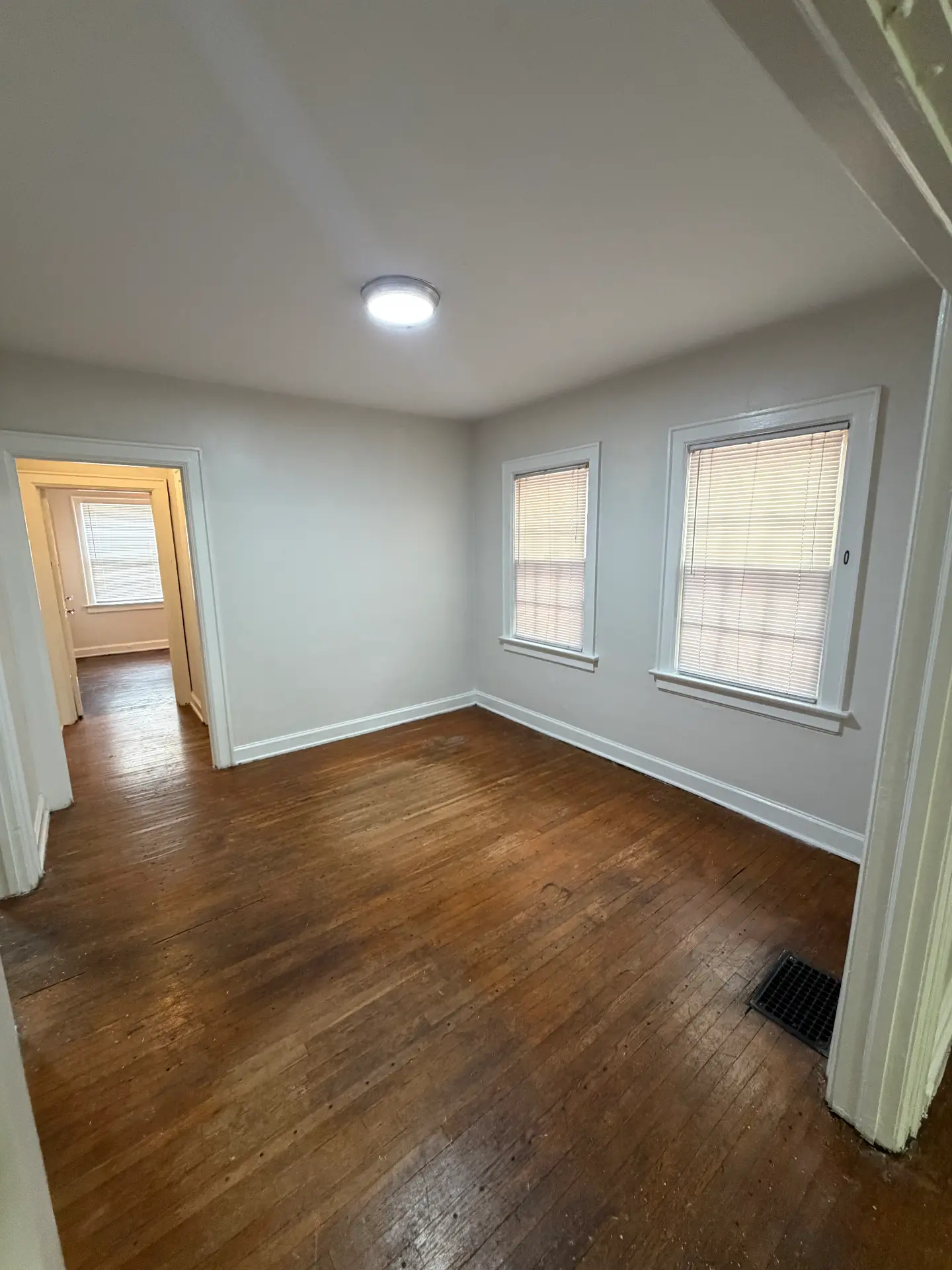 2048 Iuka Ave. D dining room with two windows and original hardwood floors