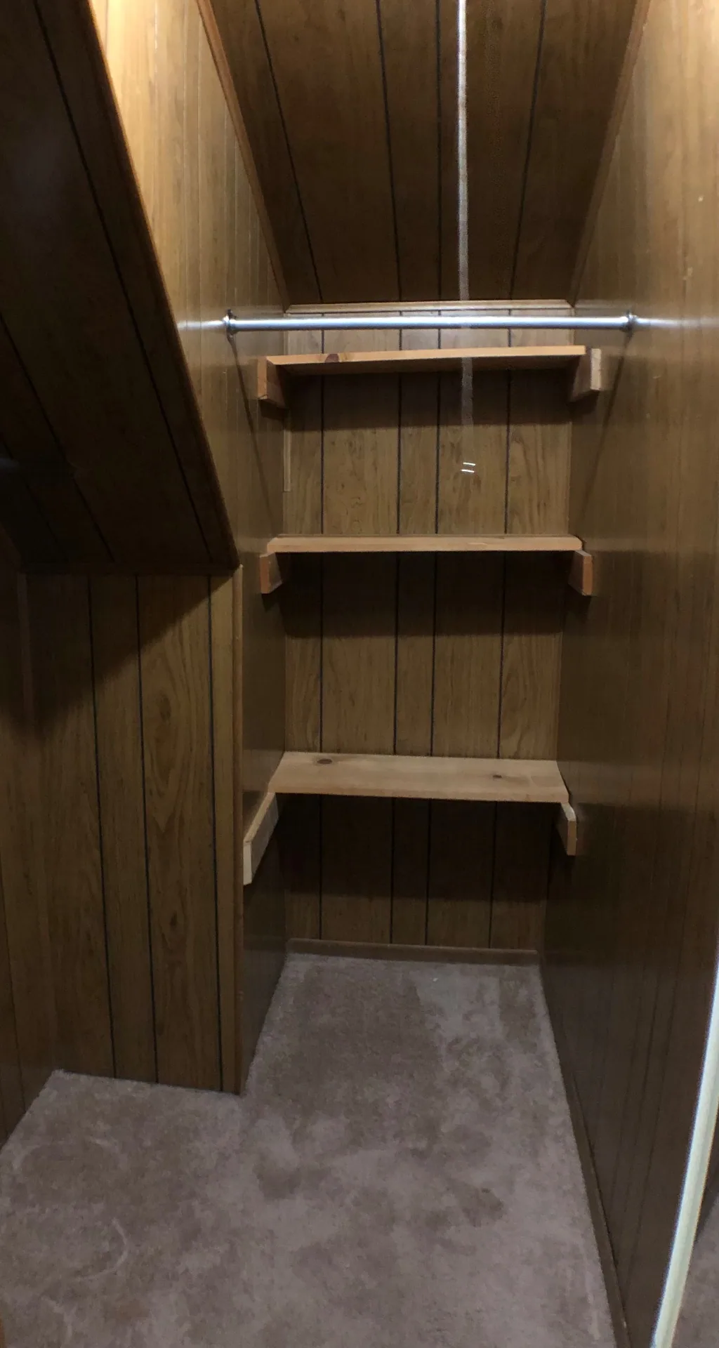 Cedar-panel walk-in closet with built-in shelves and hanging rod