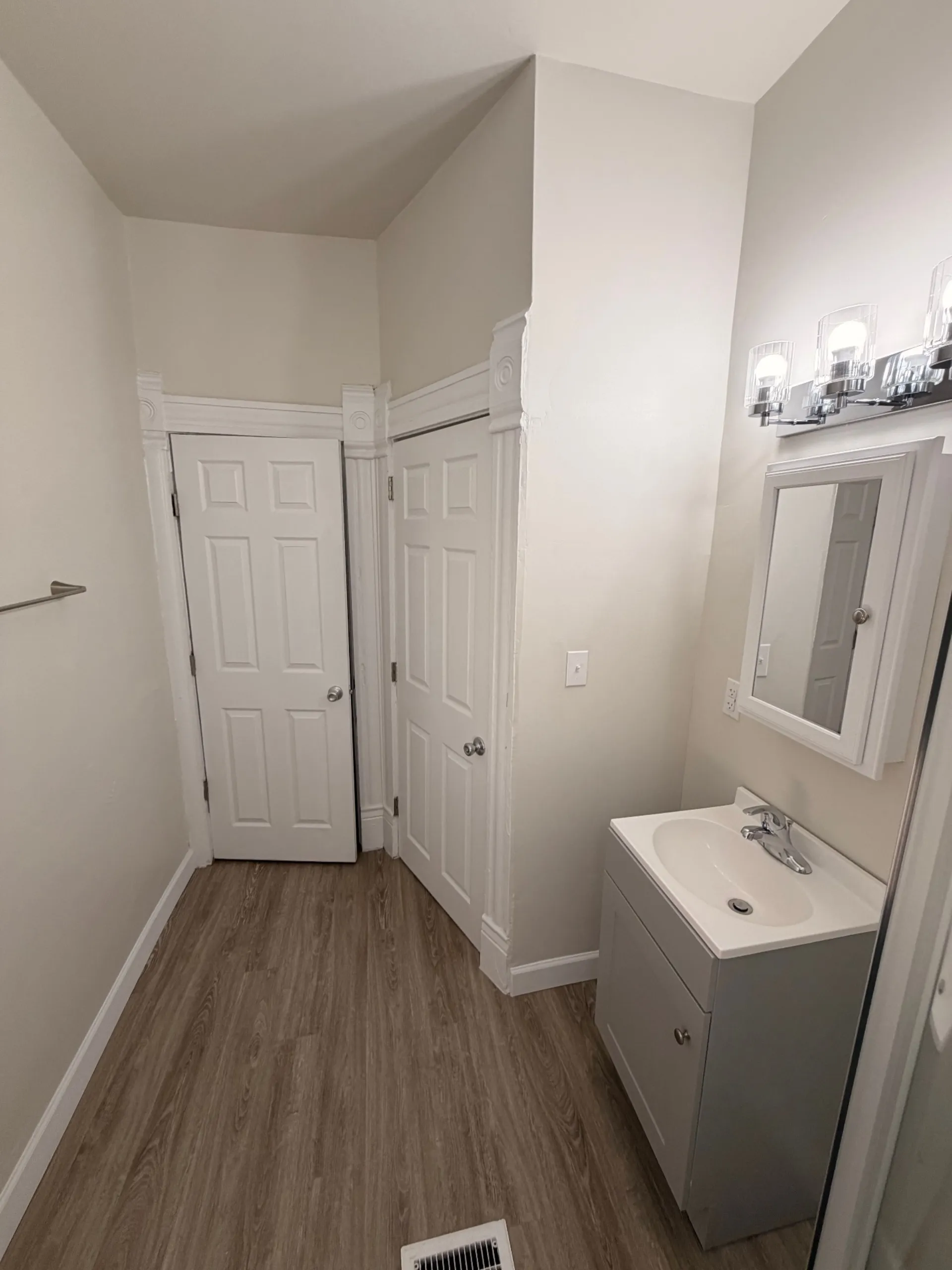 133½ bathroom entry with vanity, medicine cabinet and closet doors
