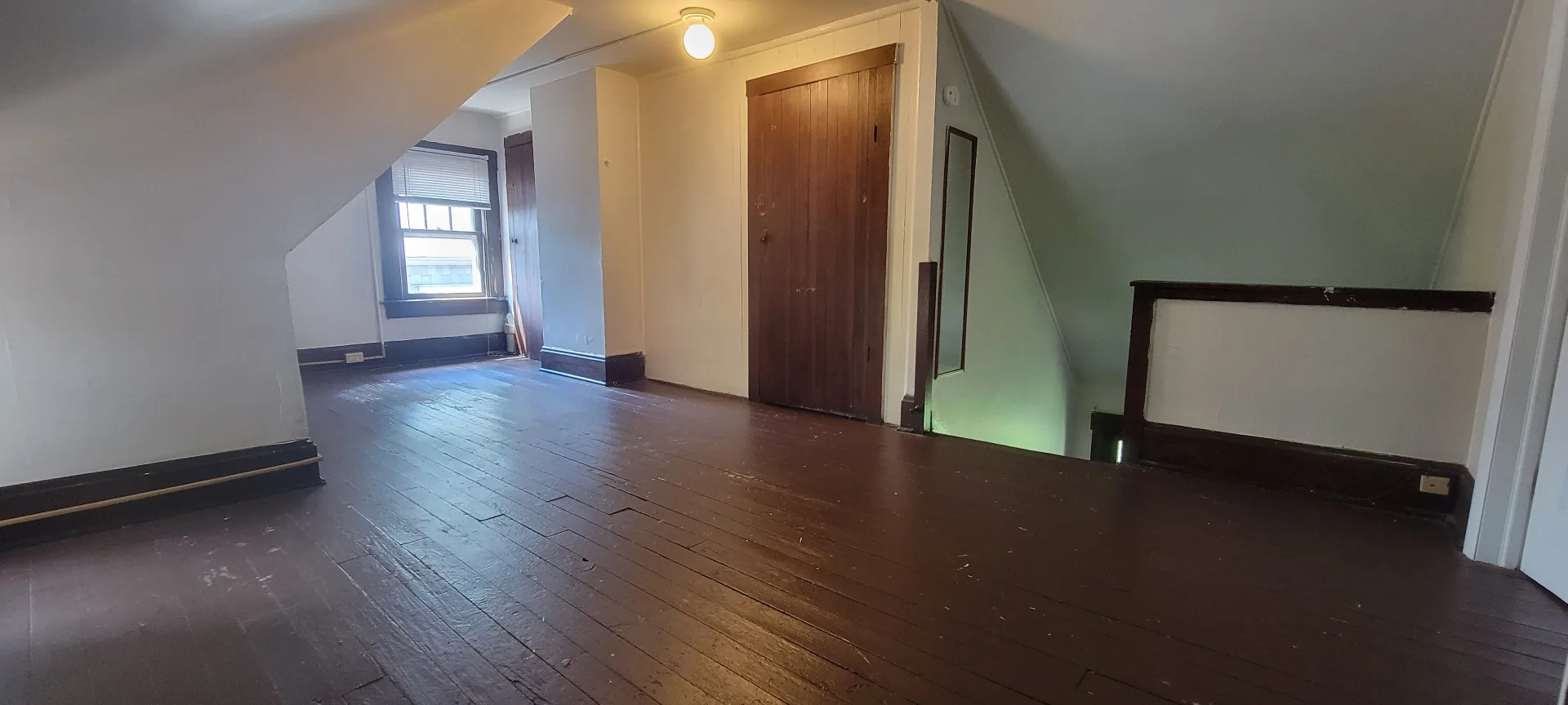 2015 Summit St. third-floor landing with hardwood floors and original wood doors