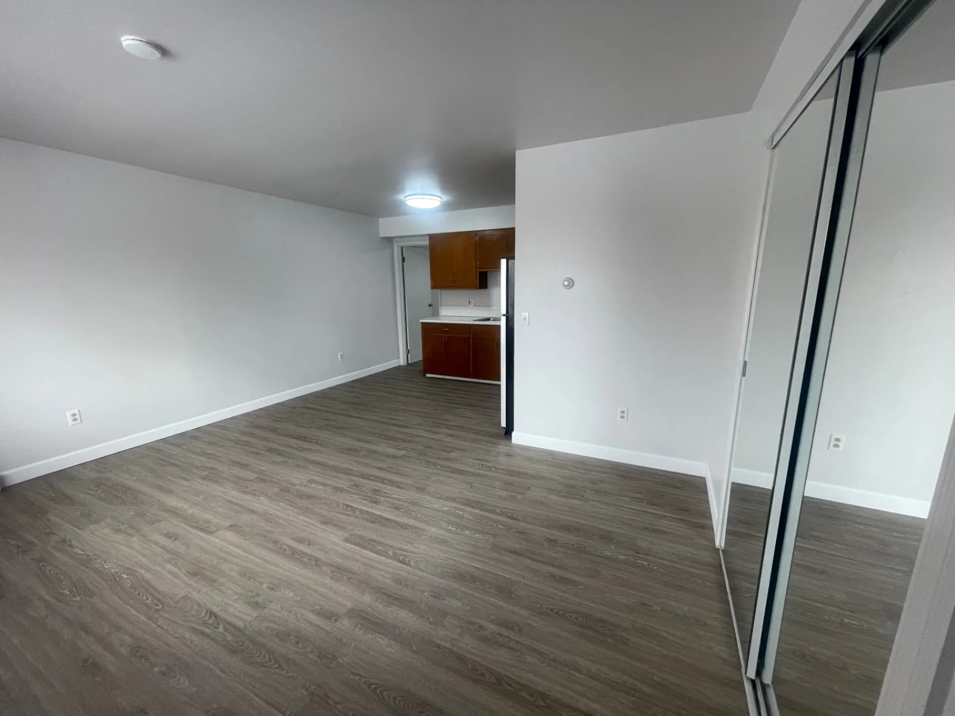 1827 N 4th St. Unit 8 living area opening into kitchen with mirrored closet doors