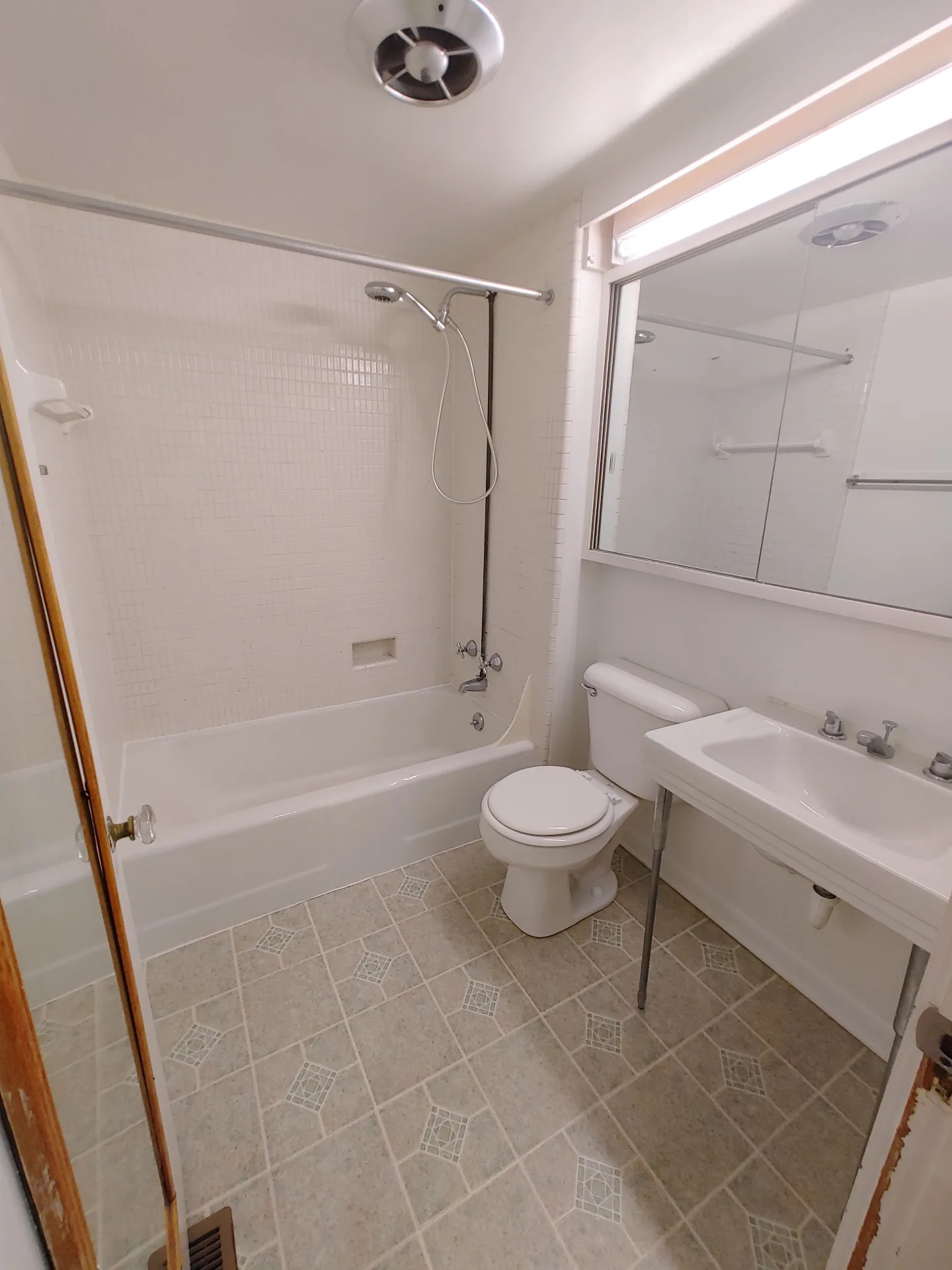 2026 Iuka Ave B full bath with white tile, tub/shower, and large vanity mirror